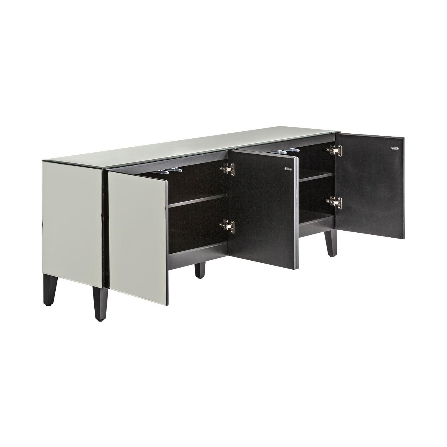 Sparkling and sophisticated all in beveled mirrored sideboard with black wooden and compas feet, four beveled mirrored doors with push-open system. Harmonious lines, graphic and original design.