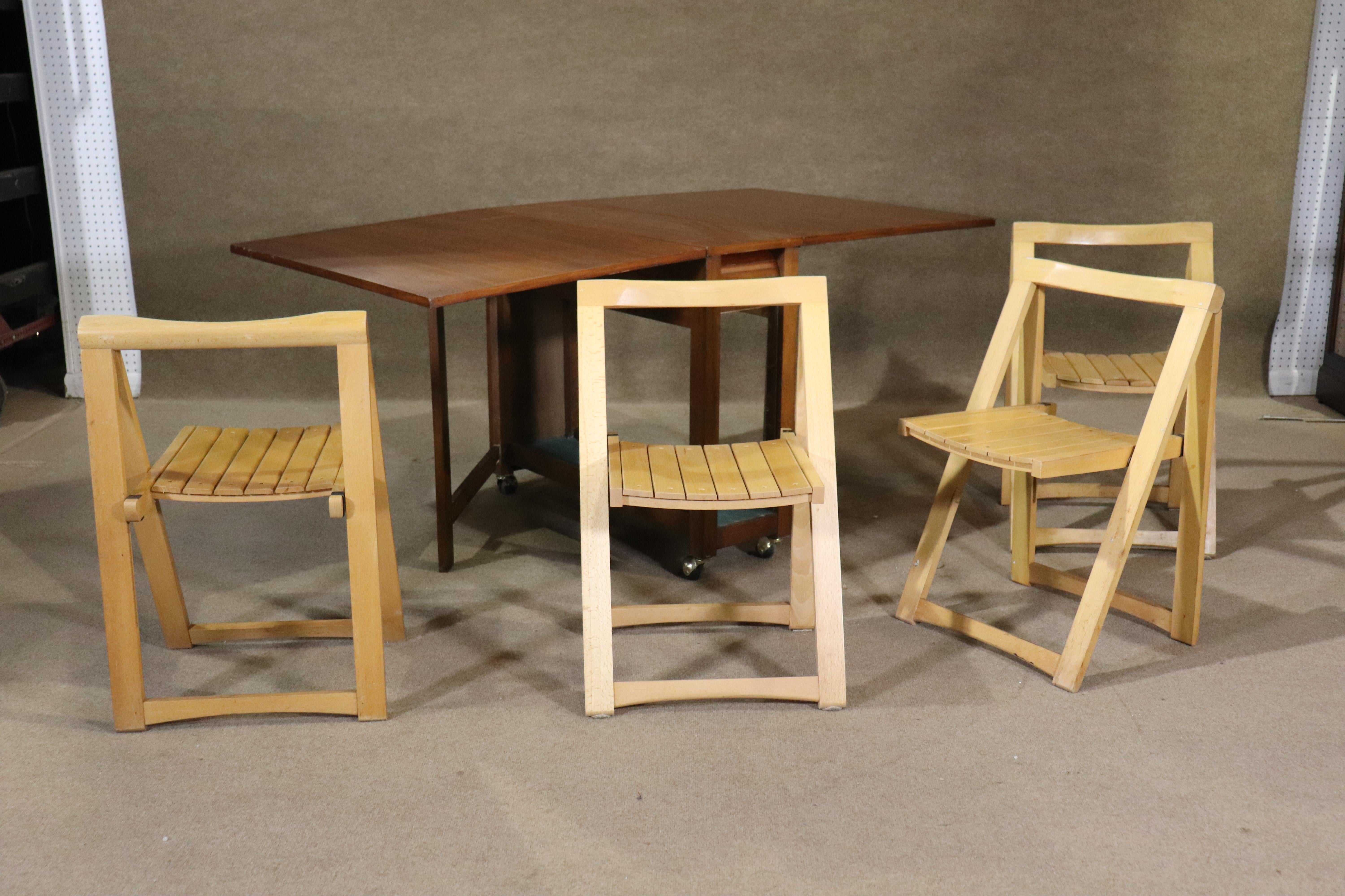 Danish made dining table with four chairs. Table has two leaves that expand from 13