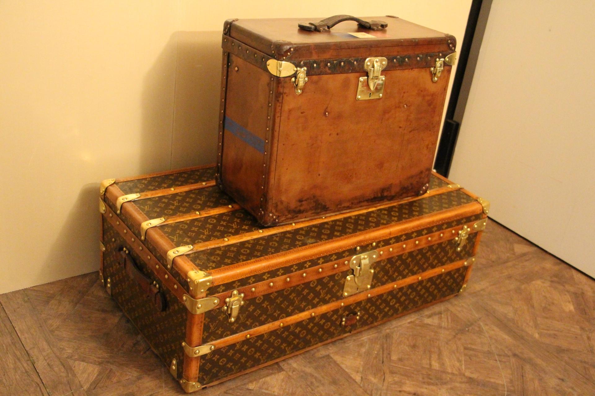 This Louis Vuitton trunk is very unusual by its dimensions and also due to the fact that it is all leather. 
Leather has got a very nice and very warm toffee color patina. It still has got its painted customized french flag on the top ans stribes