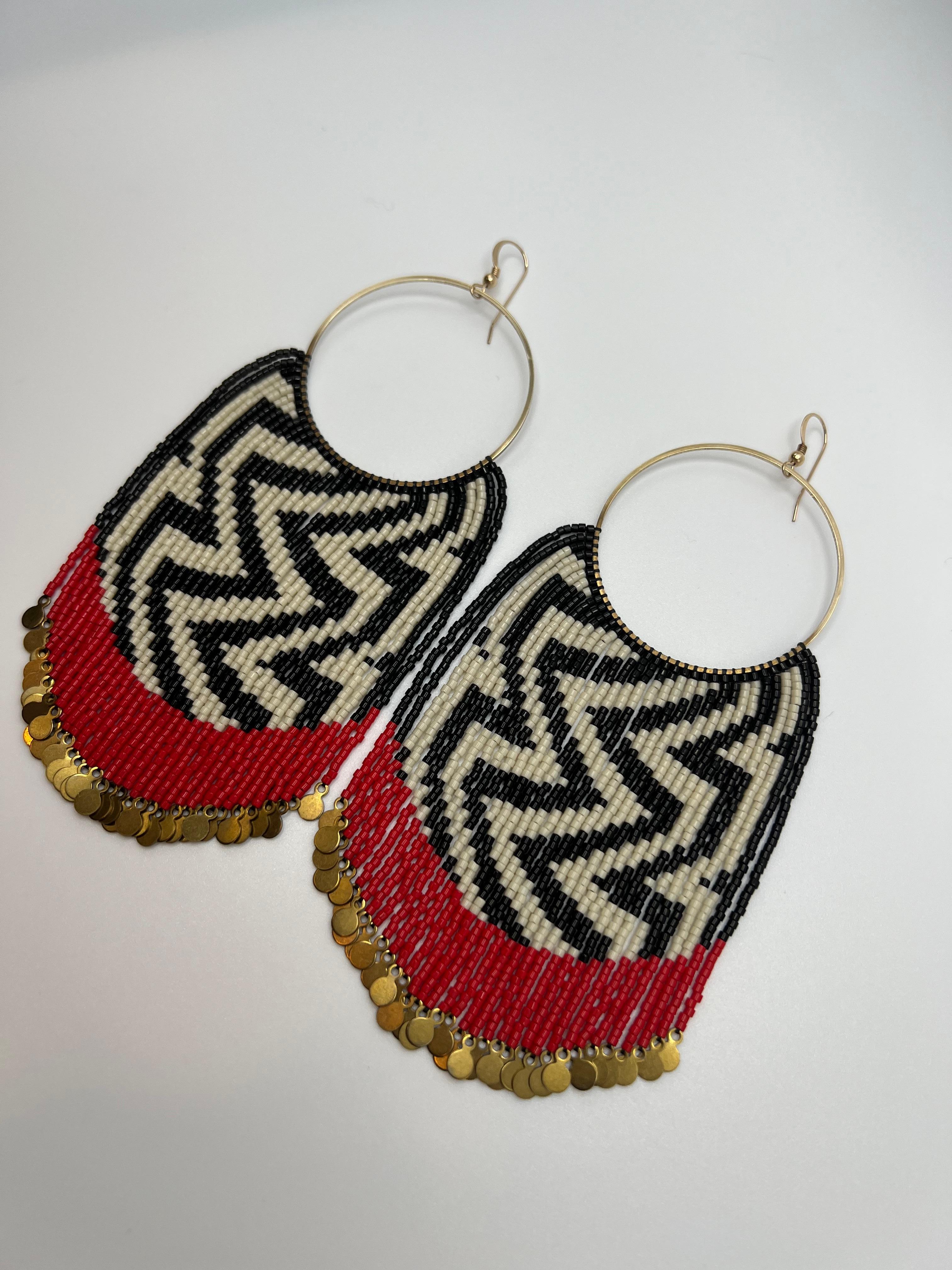 These earrings feature the Raven’s Tail weaving pattern ‘All my Ancestors’. Raven’s Tail is an ancient form of textile weaving practiced by the Indigenous Peoples of the Northwest coast of North America. Once an extinct art Raven’s Tail has seen a