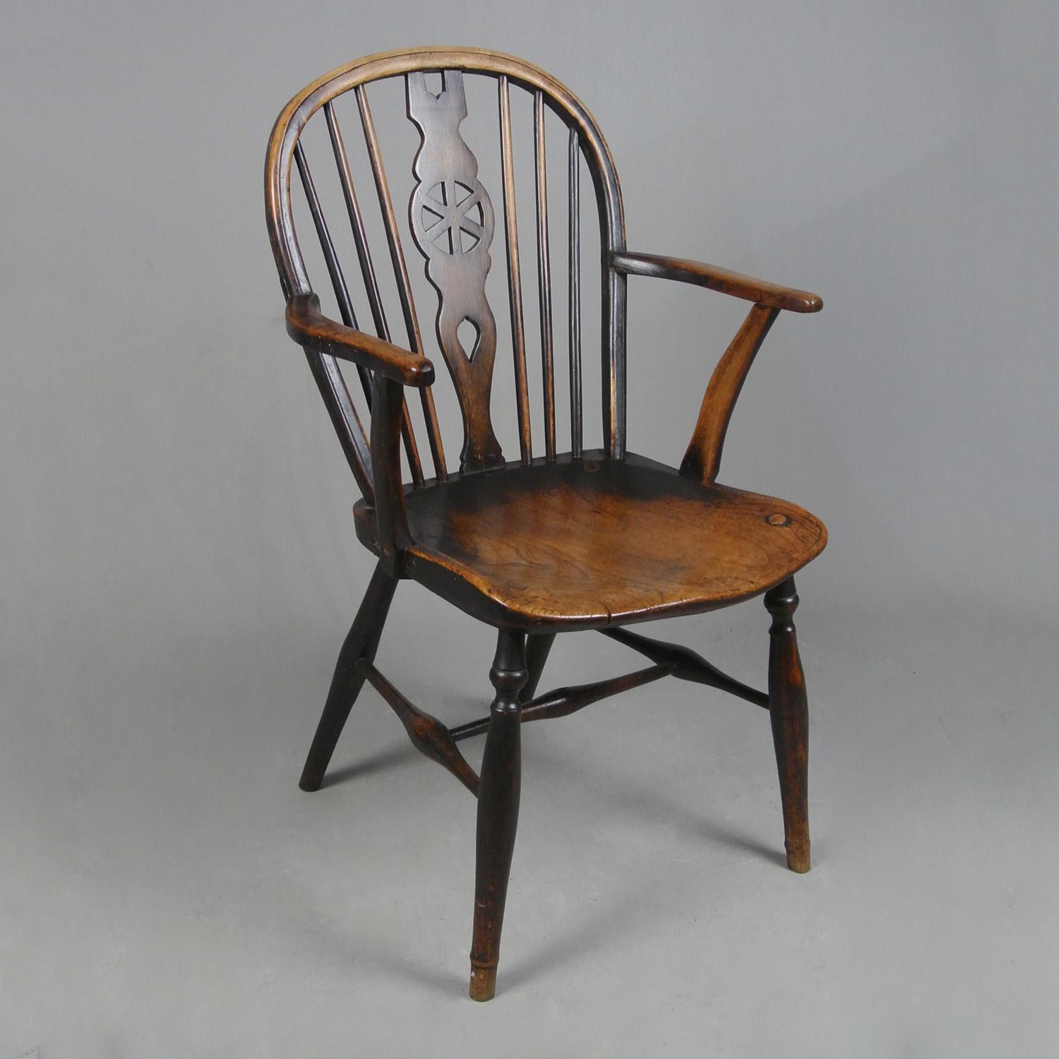 A very good, sturdy and fine example of a low back 18th century wheel back Windsor chair with a really fantastic and naturally developed colour and patina. High Wycombe and c. 1780  

The saddle seat in elm, the hoop, legs, spindles and stretchers