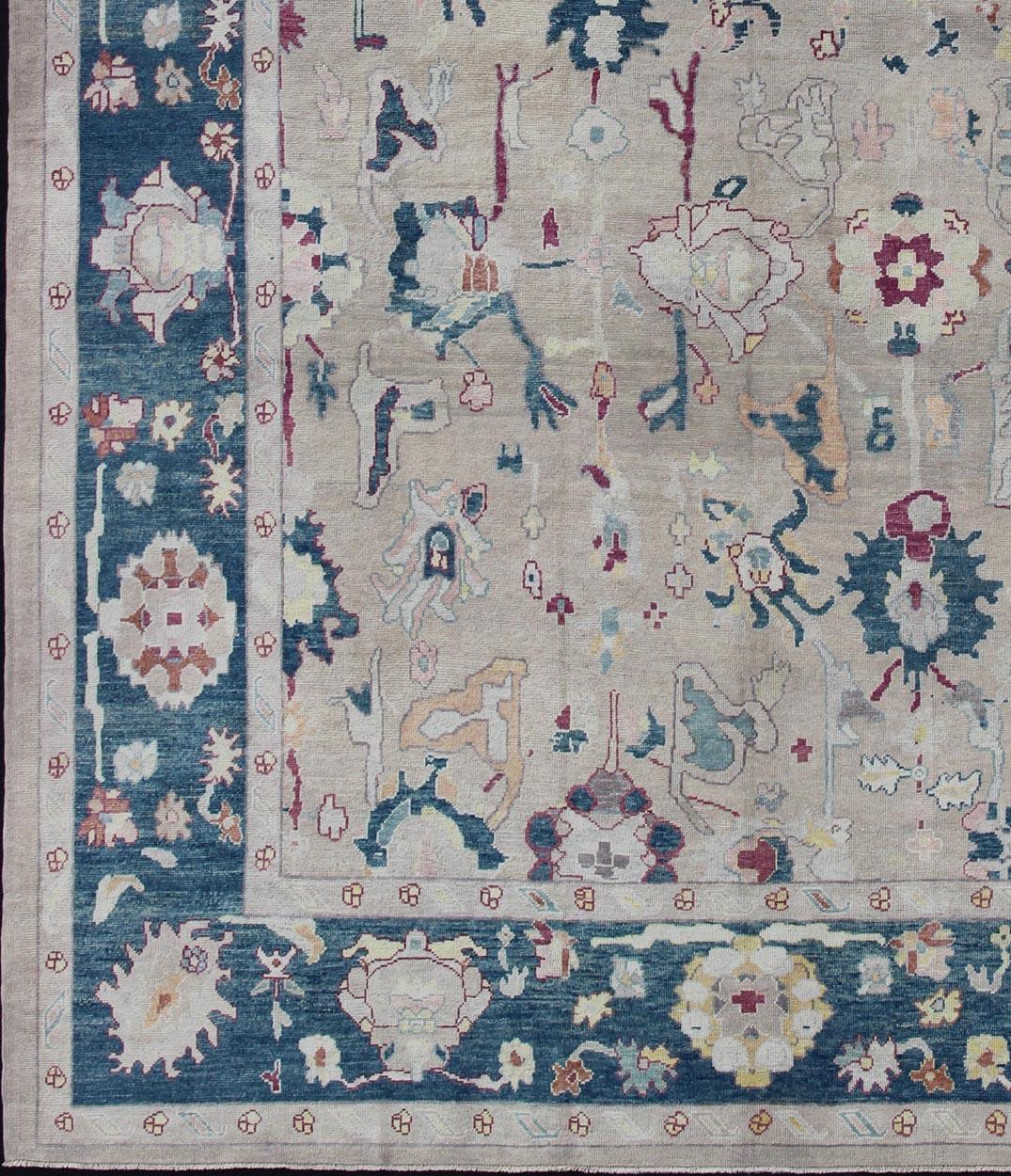 Oushak rug from Turkey with floral blossom all-over design rendered in gray, blue, ivory, and red tones. Keivan Woven Arts /  rug EN-176142, country of origin or type: Turkey 
/ Oushak
Measures: 12'3 x 16'1.
This striking Turkish Oushak rug bears a