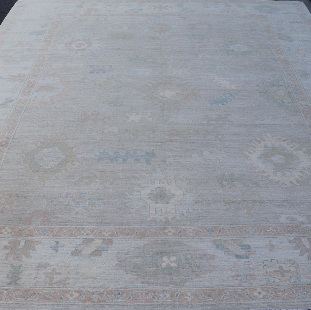 All-Over Floral Modern Oushak with Light Tan Background and Cream Border. Keivan Woven Arts rug AWR-17919 Country of Origin: Afghanistan Type: Oushak Design: Floral, all-over, abstract floral.
Measures: 10'1 x 13'10 
This Oushak was hand knotted in
