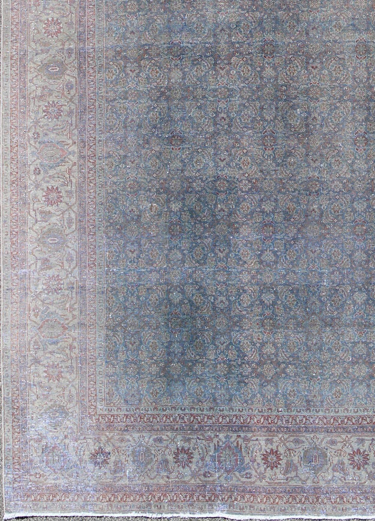 Large all-over Herati design antique distressed Persian Tabriz rug in shades of light blue grey and soft red, Keivan Woven Arts / rug#17-1102, country of origin / type: Iran / Tabriz, circa 1930

Measures: 9'9 x 13'5.

This antique large Persian