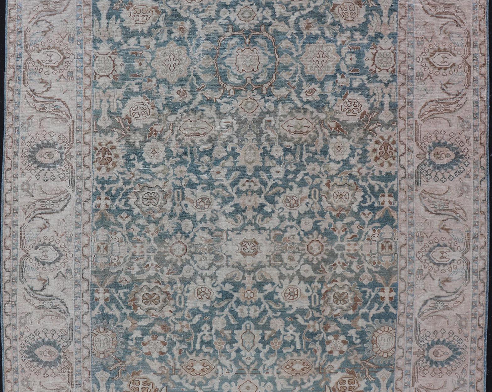 Measures: 7'0 x 9'10 

This antique persian Hamadan displaying a light green background with a cream border. The design is floral, the center having a tight and busy design, heavily decorating the field with vines, flowers, and other motifs. The