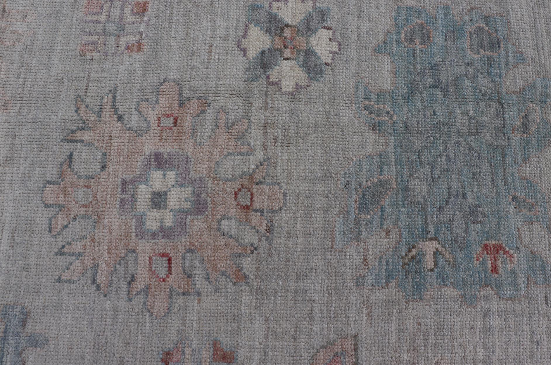 All Over Modern Floral Oushak with A Light Blue-Gray Field and Border
Keivan Woven Arts; rug AWR-8546 Country of Origin: Afghanistan Type: Oushak Design: All-Over, Floral, Arabesque-Floral 21st Century
Measures: 9'11 x 14'0 
This hand-knotted Oushak