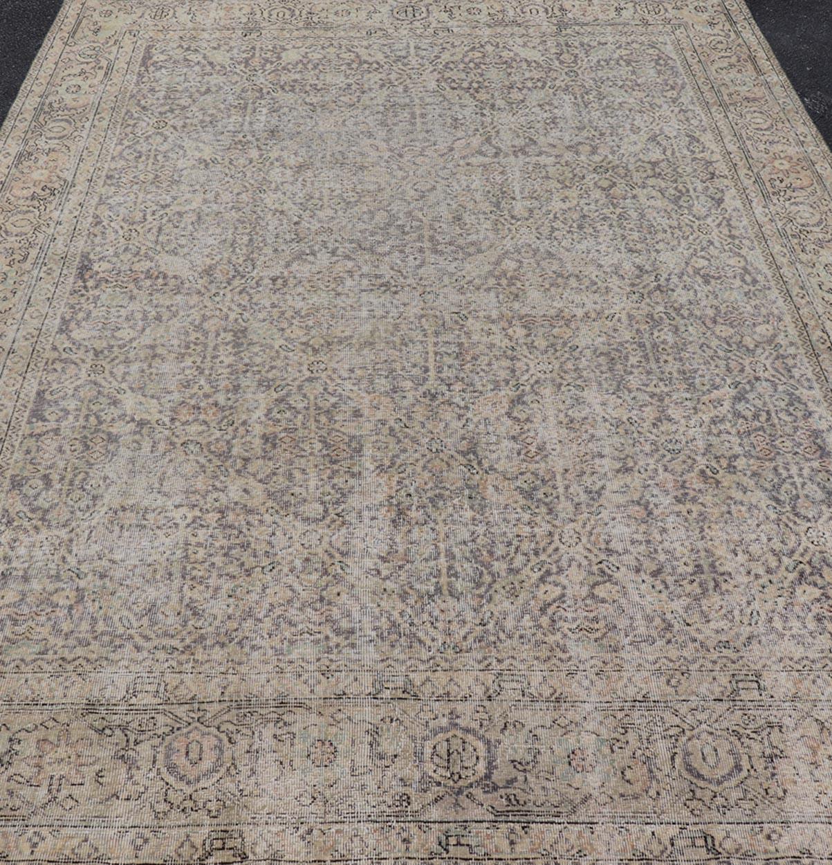 All-Over Vintage Turkish Distressed Rug in Cream, Lavender, Taupe, and Green. Keivan Woven Arts / rug EN-15415, country of origin / type: Turkey / Oushak, circa 1950.

Measures: 7'9 x 11'2 

This distressed rug Turkish vintage rug bears a light