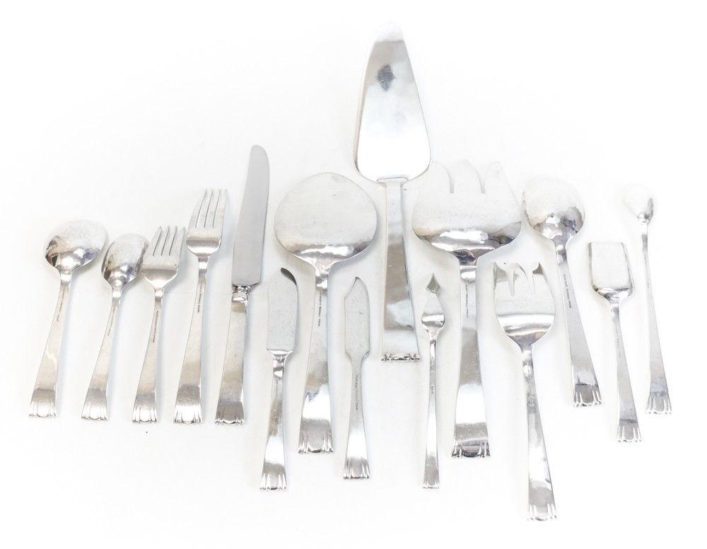 A stunning 180 piece Allan Adler sterling silver flatware service for 24 in Modern Georgian. Lightly hand hammered to the verso of the pieces with a modernist hand chased scroll design to the ends of the handles. Marked Allan Adler. Comes in a large