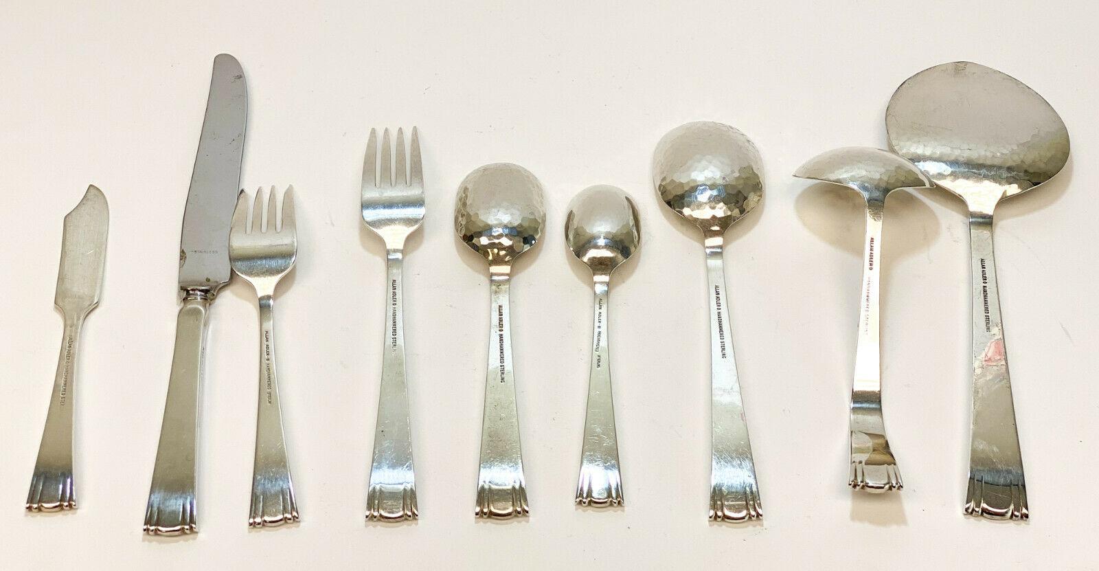 6 piece Allan Adler sterling silver flatware service for 10 in Modern Georgian, Issued 1970. Lightly hand-hammered with a modernist scroll design to the ends of the handles. Marked Allan Adler to the verso.

The service includes:
- 1 serving
