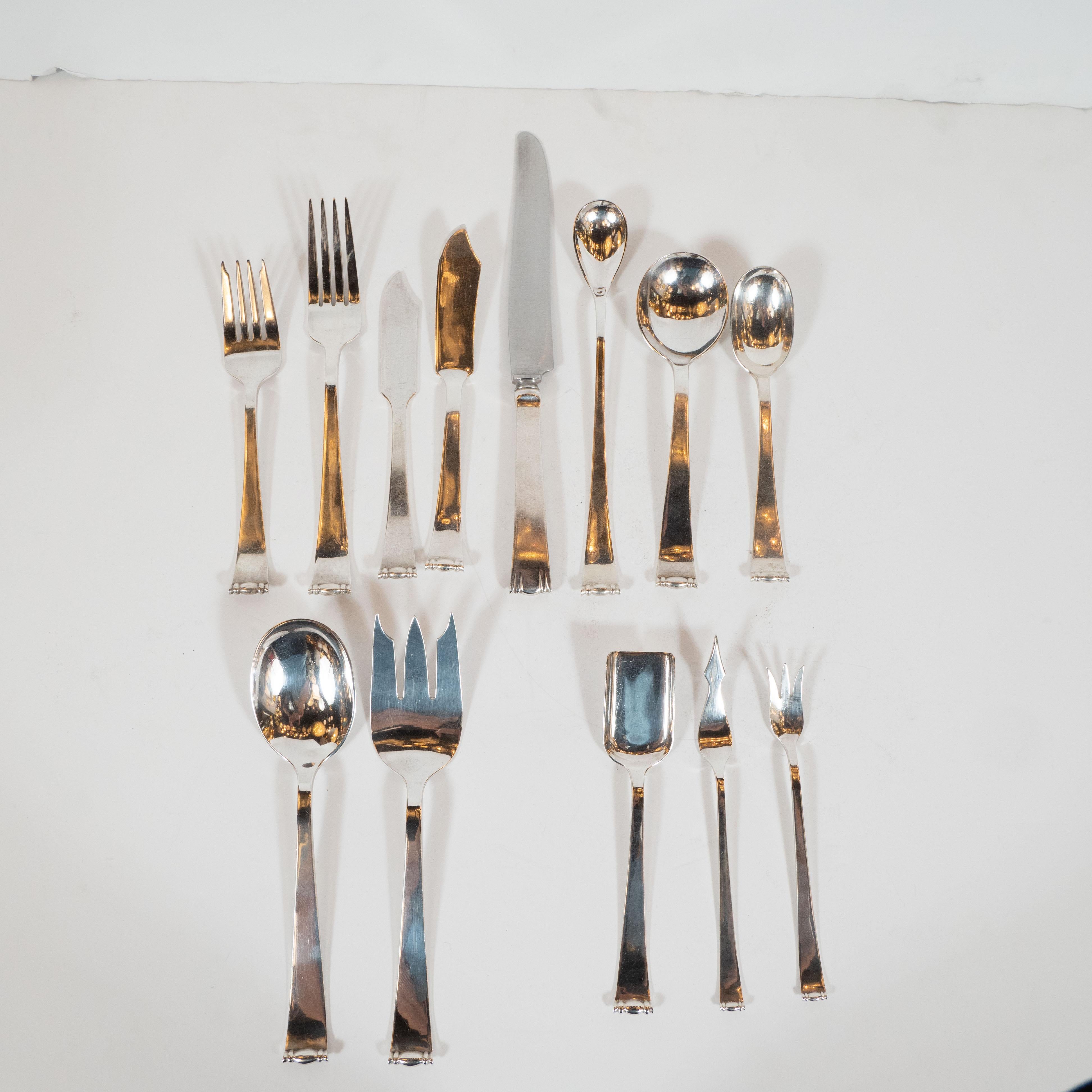 This stunning sterling silver flatware service was designed by the celebrated American silversmith Allan Adler and was handwrought in his Los Angeles studio circa 1945. During the 1940s, Adler won over the Hollywood elite with his clean, simple,