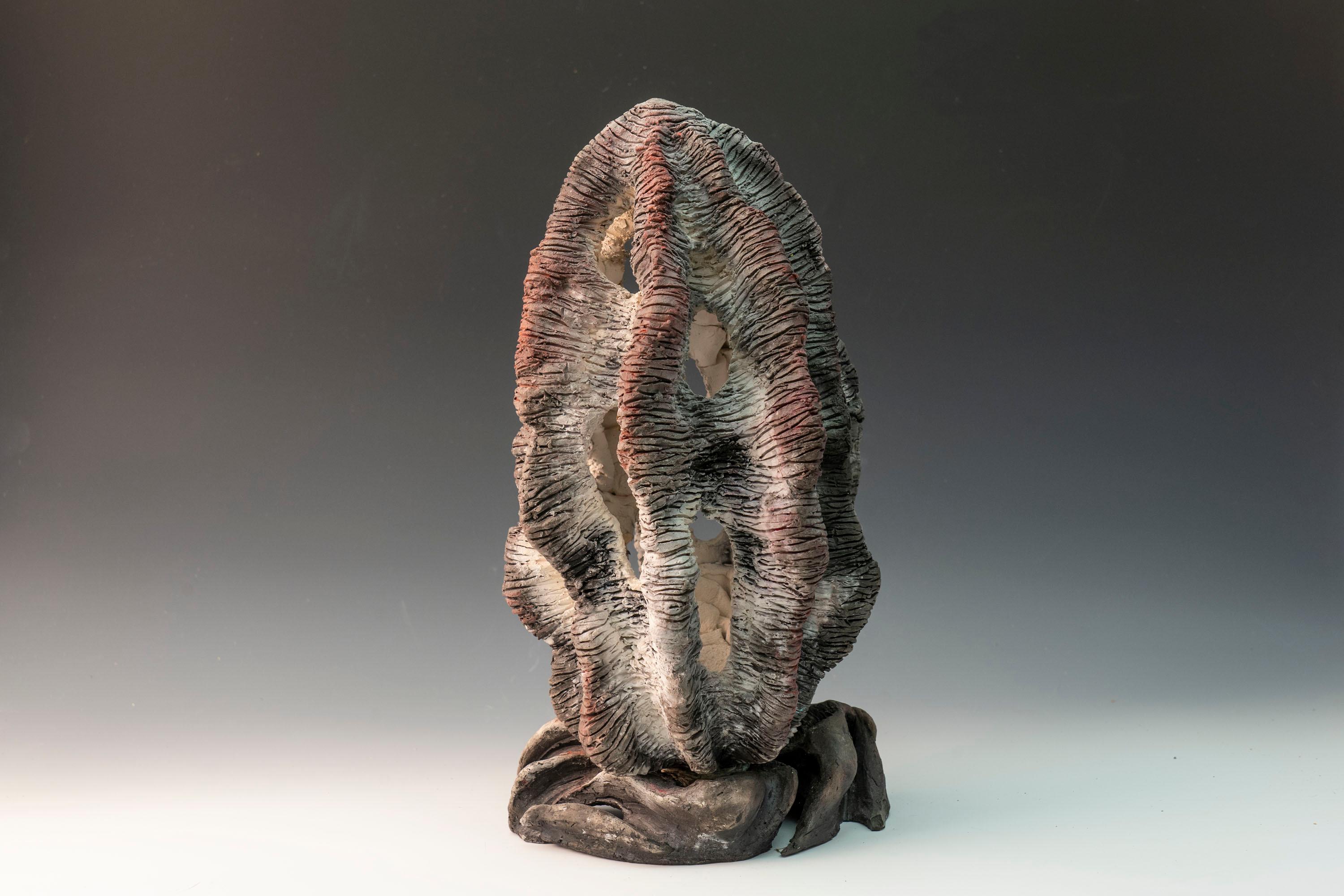 Captured Light, textured ceramic in grays and pinks, embodies the essence of clay in its organic shapes that refer directly to the earth and nature. The artist says 