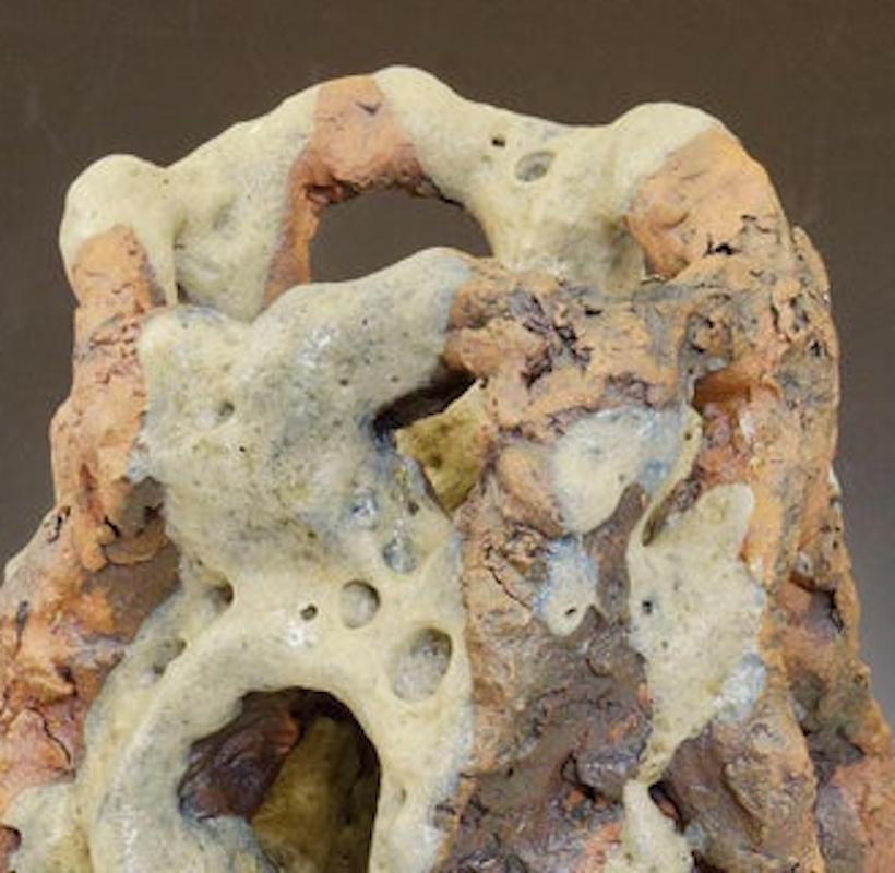 Eroded Tower, celadon green colored, textured ceramic, embodies the essence of clay in its organic shapes that refer directly to the earth and nature. The artist says 