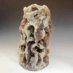 "Eroded Tower, " celadon green colored textured ceramic, embodies essential clay