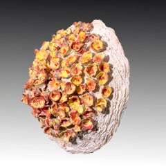 "Flower Emergence", yellow and orange textured ceramic, embodies essential clay
