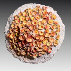 "Flower Emergence", yellow and orange textured ceramic, embodies essential clay