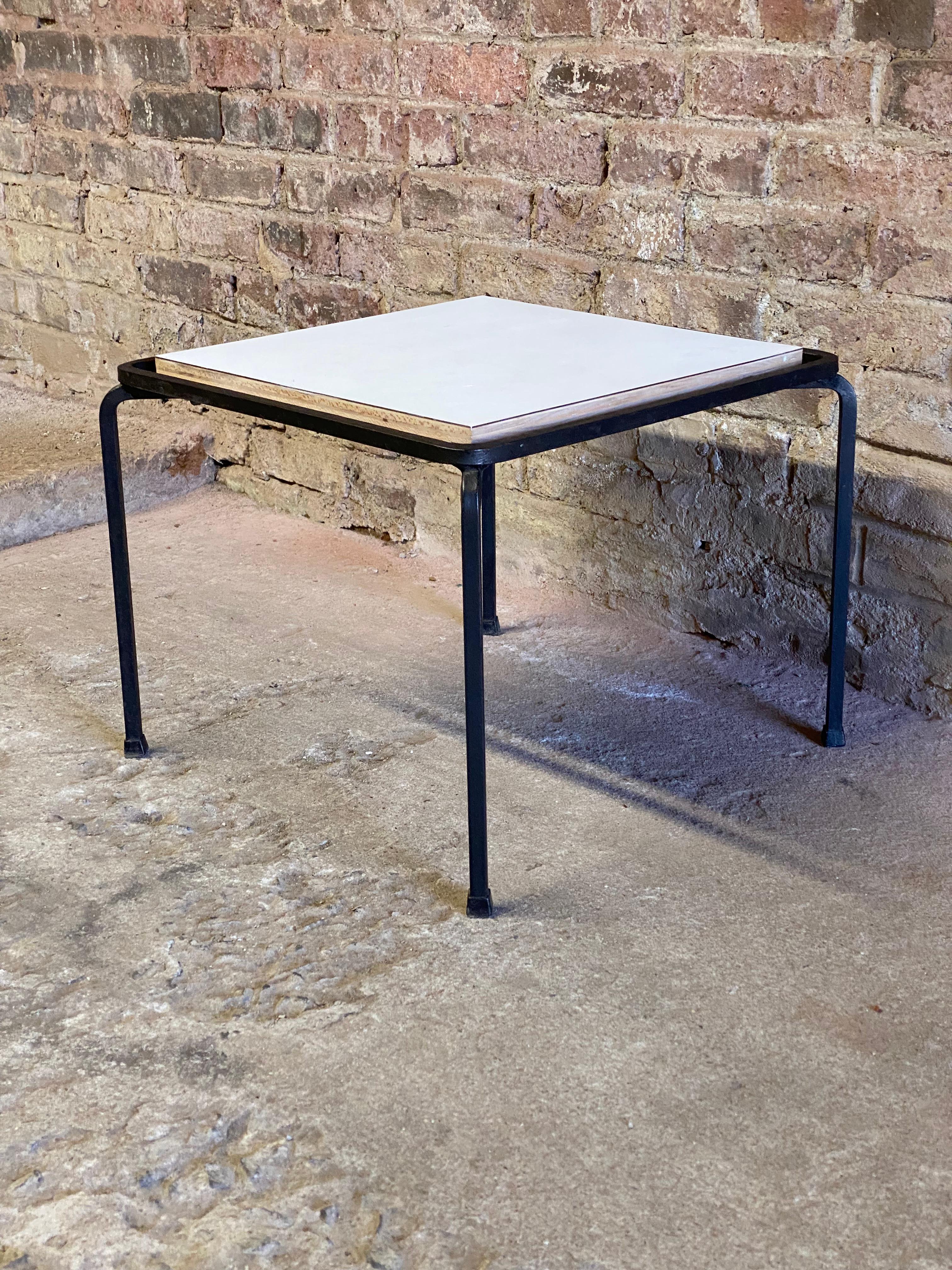 Allan Gould for Reilly-Wolff white laminate top and iron base end table. Circa 1950-60. Structurally sound and sturdy construction. Good overall condition with some light scratches to laminate top. Minor edge wear. Wear commensurate with age and