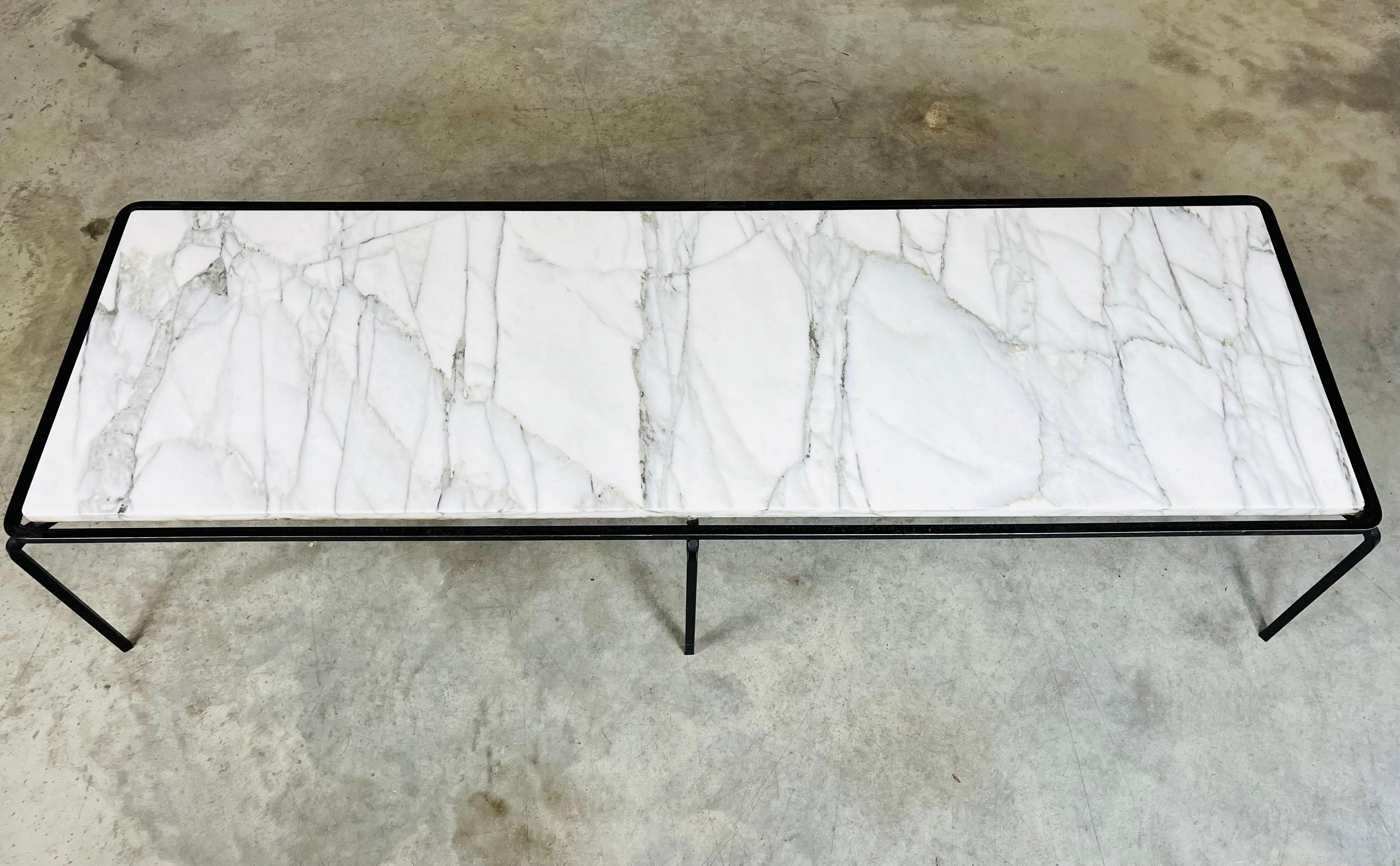 An elegant Carrara marble and black iron coffee table by Allan Gould and produced by Reilly-Wolff Associates, USA, 1950s.
In fabulous vintage condition having appropriate patina. Solid and sturdy. The marble has been polished, the frame carefully
