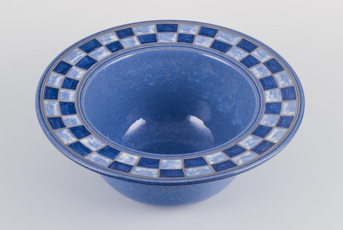 Pre-owned goods are exempt from import duties for U.S. customers. 
Therefore, no import tariffs will be applicable to your purchase.

Allan Hytholm, Danish studio ceramist.
Large unique ceramic bowl.
Glaze in bluish tones with earth-colored