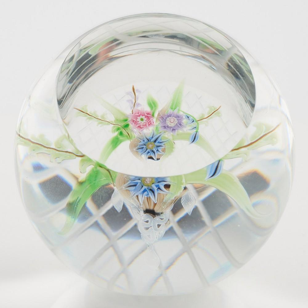 Heading : An Allan Scott Caithness Whitefriars Hanging Basket Lampwork Paperweight 1988
Date : 1988
Origin : Scotland
Features : Three lampwork and millefiori flowers with facet cut window and hatched base, Whitefriars monk cane to set up
Marks :
