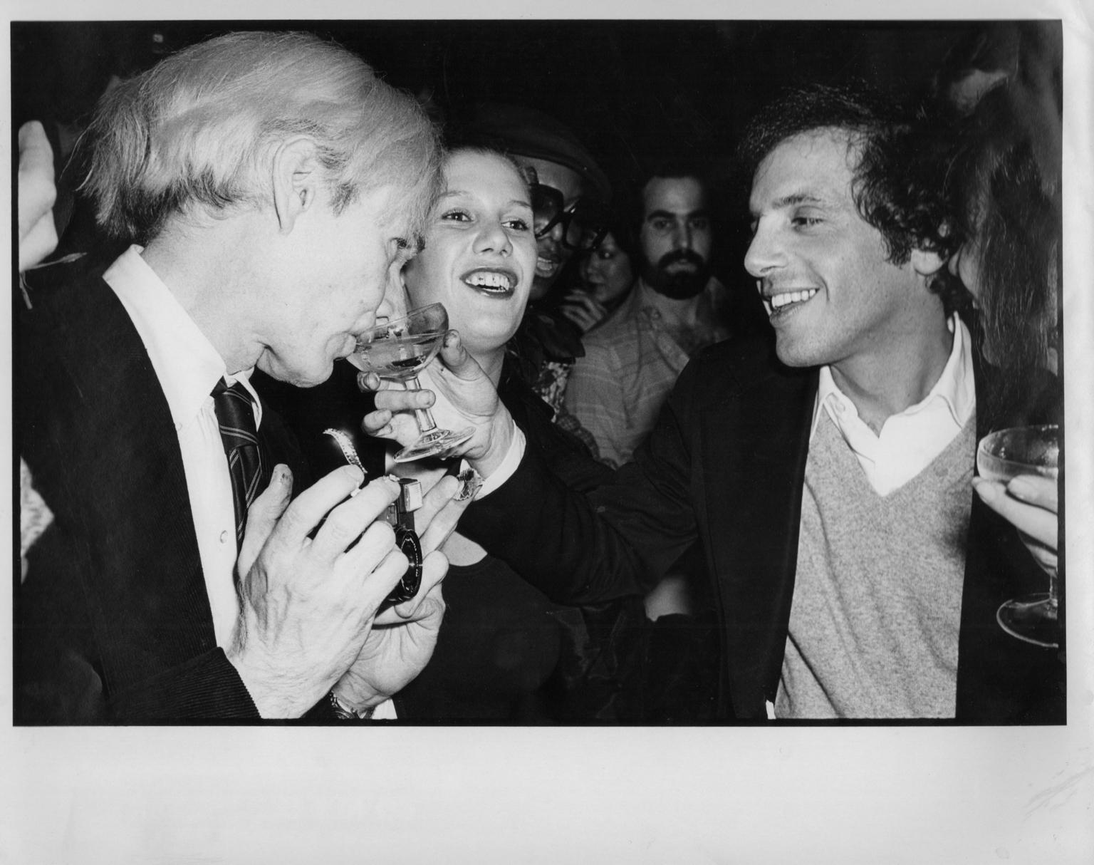 Allan Tannenbaum Black and White Photograph - Steve Rubell Gives Andy Warhol a Drink at Studio 54 - Gel Silver Vintage Print