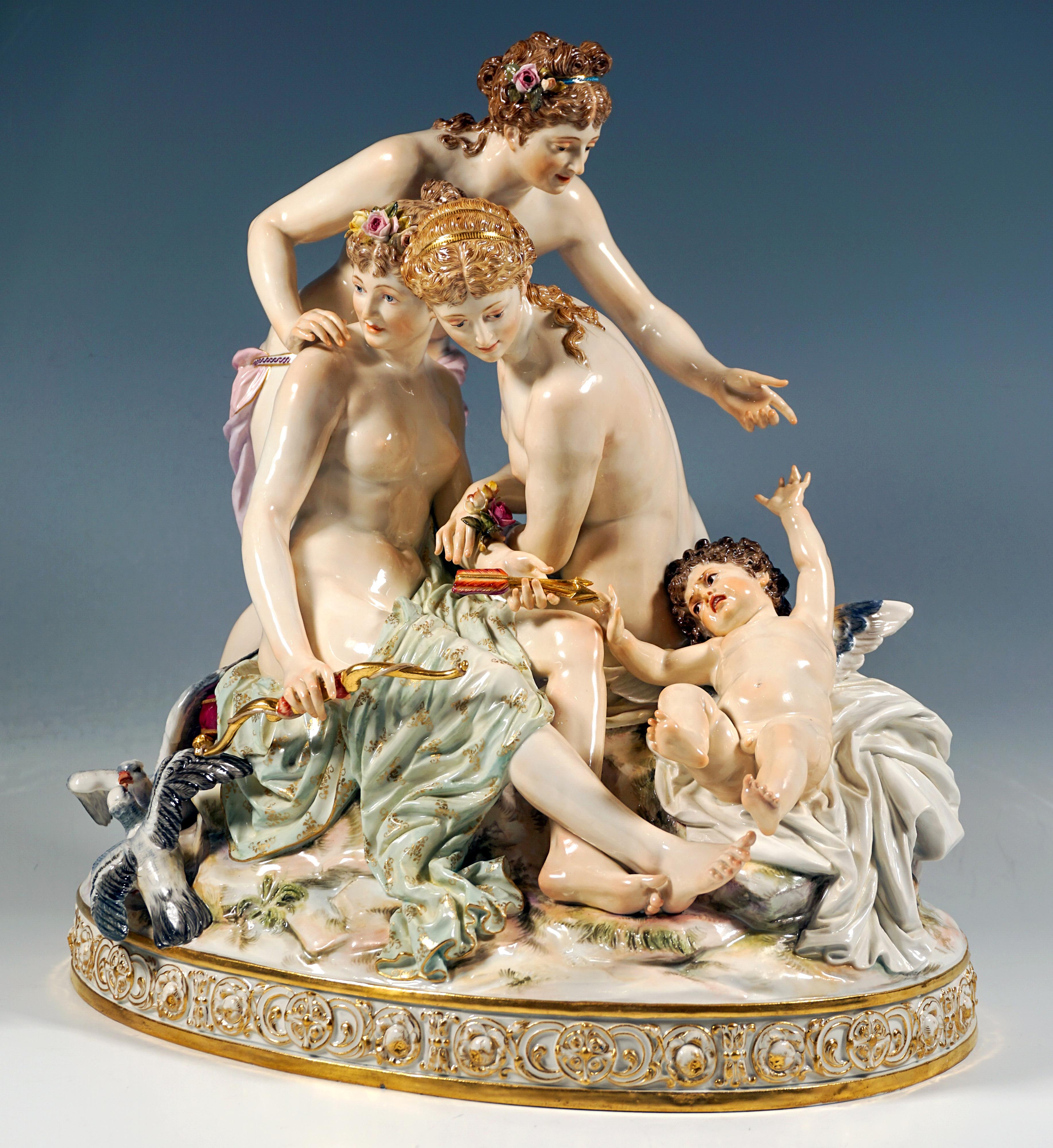 Very delicate Meissen porcelain group of the late 19th century:
Three beautiful young women with artfully pinned-up hair and wrapped in loose cloths grouped on a high towering rock, two facing each other seated on red velvet cushions with gold