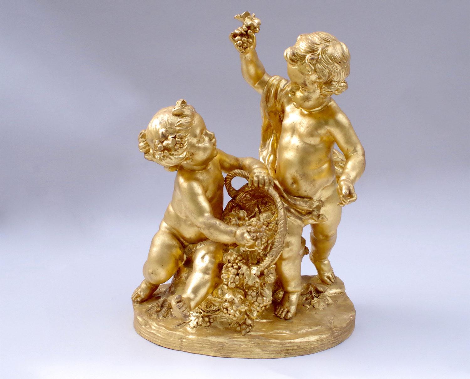 Atelier Prométhée, author. 

Gilt and patinated terracotta sculpture representing games of putti.
Allegory of the Grapes Harvest figuring a girl tipping a basket of grapes while a boy raises his hand showing a vine.

In the style of the 18th