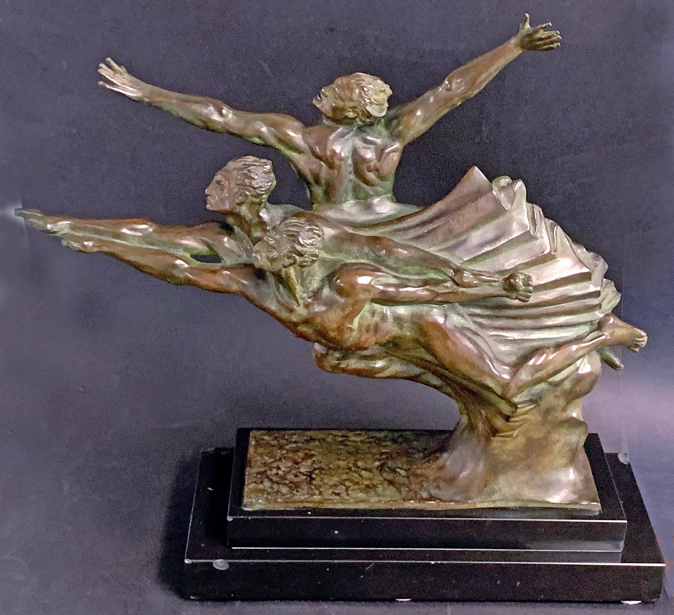 Large, rare and dramatic, this Art Deco bronze by Robert Delandre, circa 1930, depicts three nude male athletes all straining to reach the finish line of the race, their arms straining forward to win, and upward in ecstatic joy. The concentration