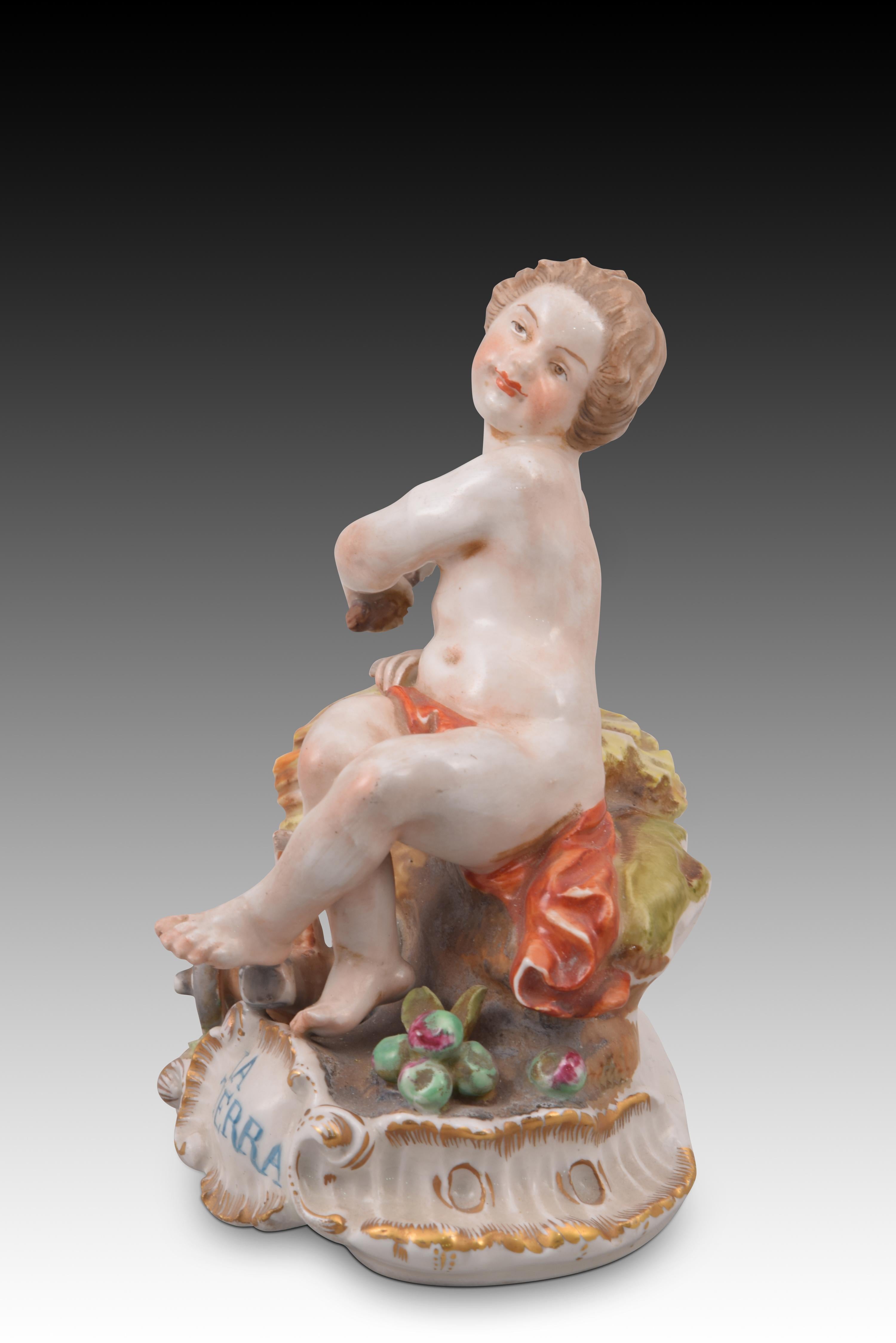 Allegory of the Earth. Glazed porcelain. Hispania porcelain, Manises, Spain, 20th century. 
With mark on the base.
 Porcelain figurine enameled with touches of gold that shows a half-naked boy, accompanied by some farming equipment (plough, etc.)