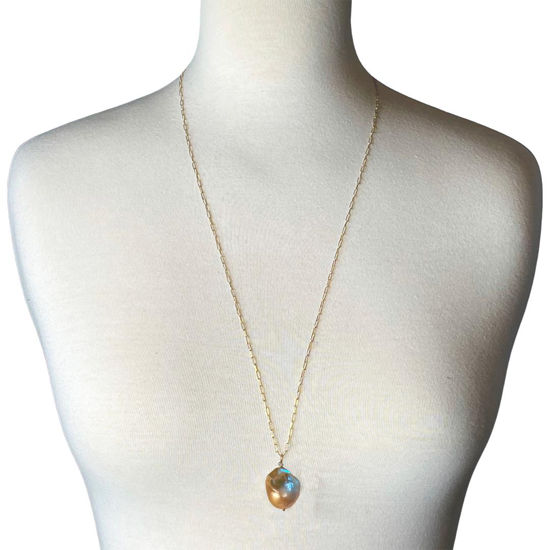 Handcrafted with a beautiful Blush Baroque Pearl, the pendant hangs from a 30