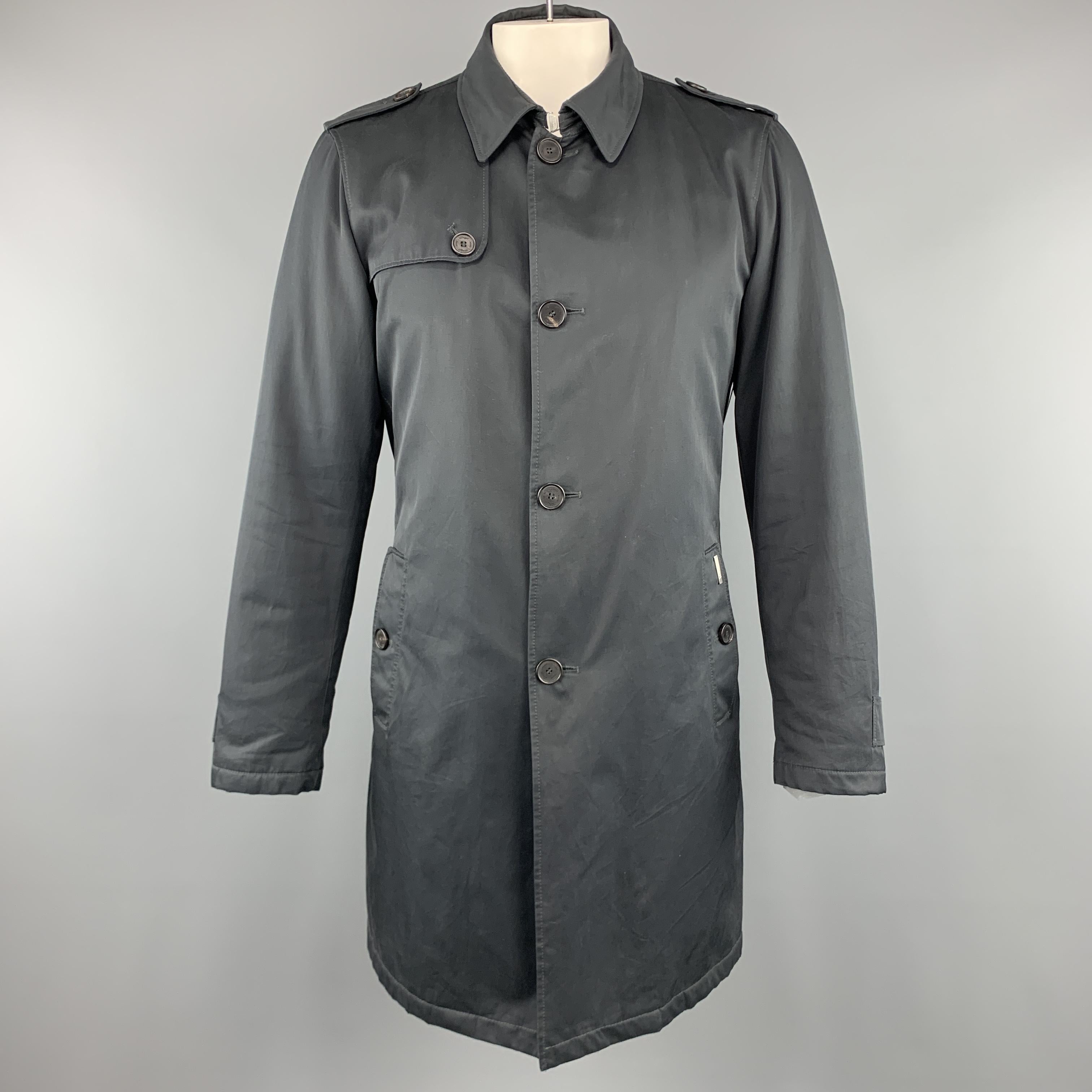 ALLEGRI trench coat comes in a muted navy nylon twill with a pointed collar, storm flap, epaulets, flap pockets, belted waist, and detachable liner. Made in Portugal.
 

Very Good Pre-Owned Condition.
Marked: IT 52

Measurements:

Shoulder: 18