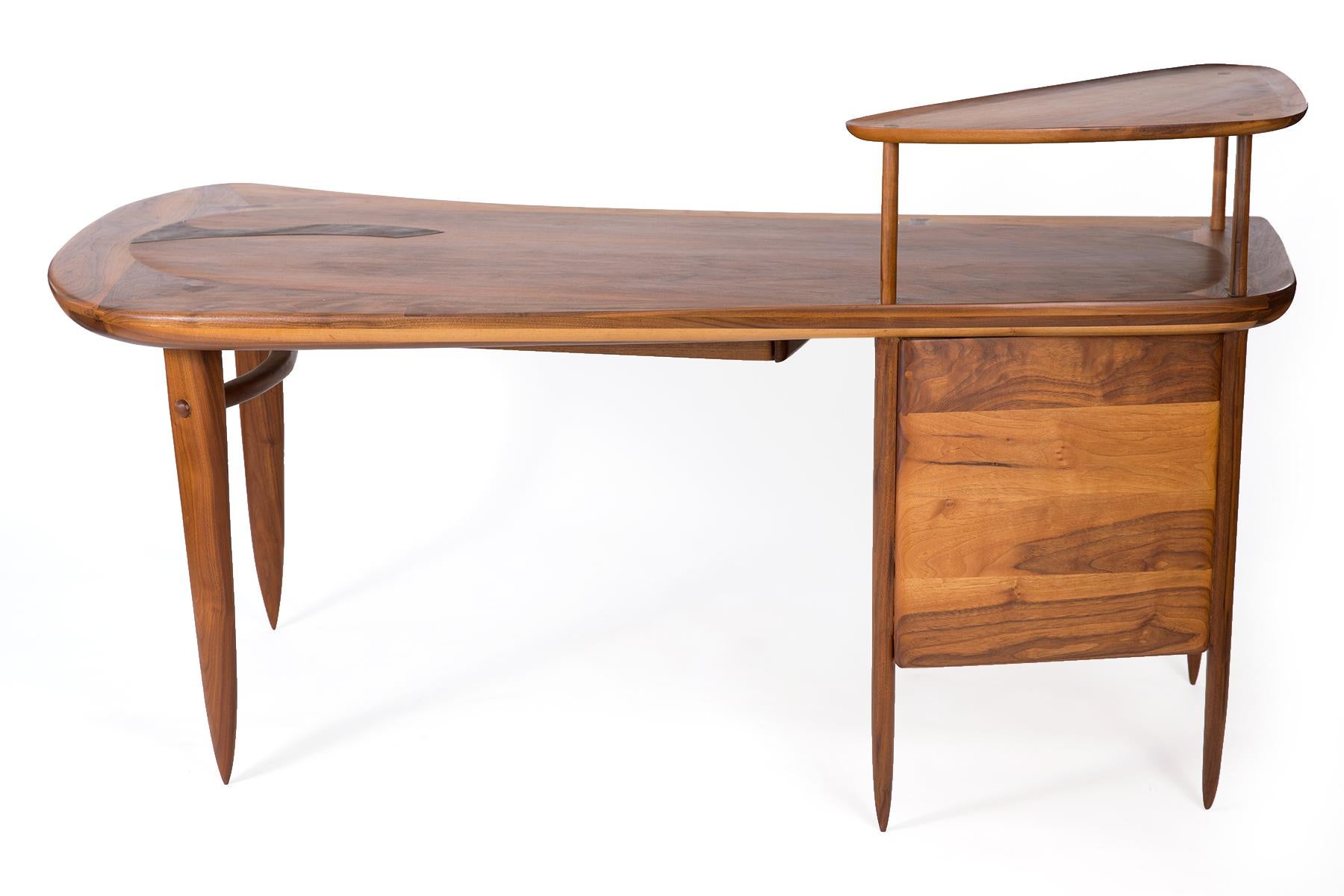 Walnut and steel one off desk by Arizona designer Allen Ditson, circa 1959. This sculptural and rare example has tapered solid walnut legs, free form solid walnut top with inset steel detailing, and is finished on all sides.

Dimensions: 71