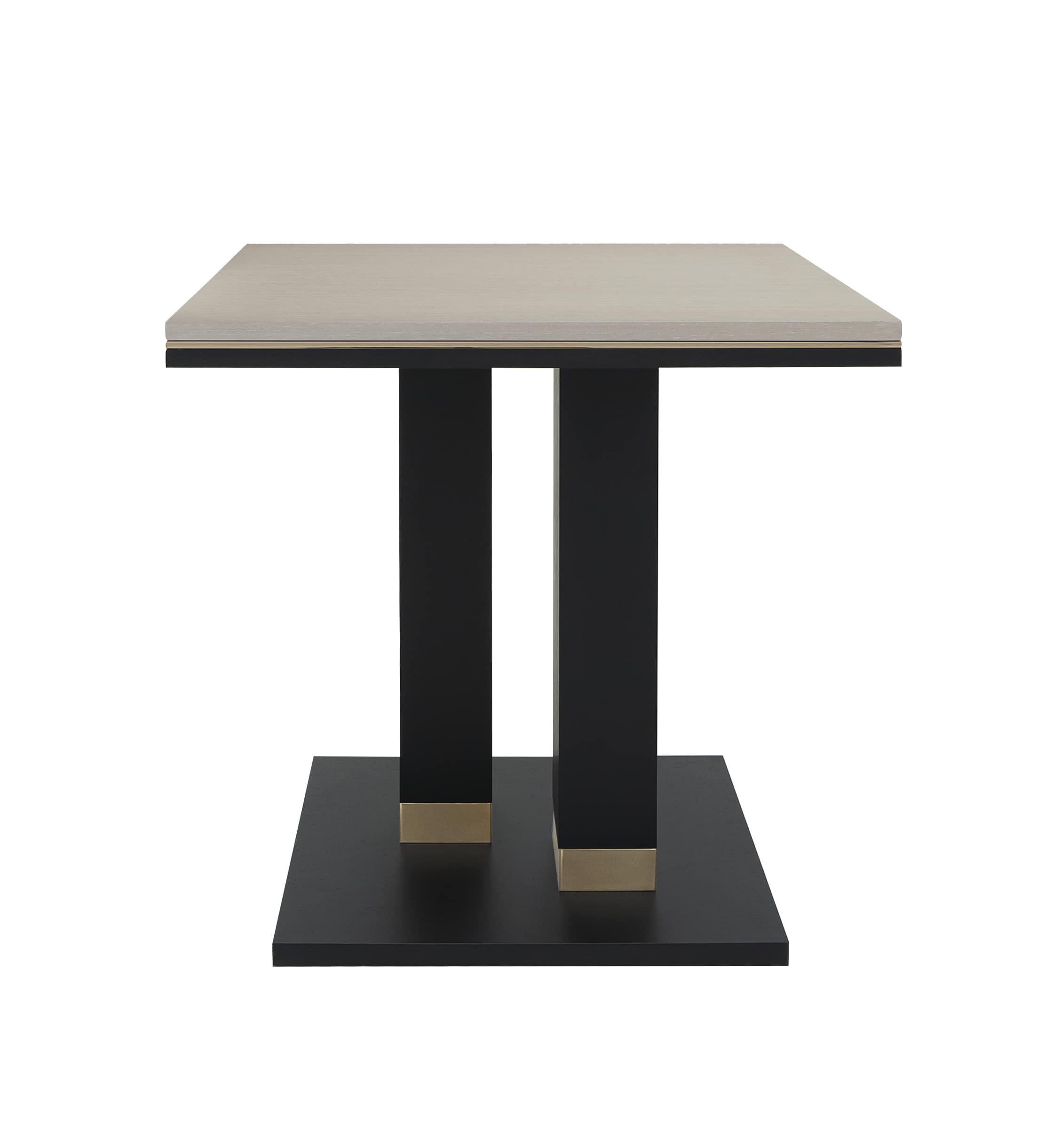 Il tavolino Alley presenta una silhouette audace ma raffinata, perfetta per gli interni contemporanei. La sua caratteristica base a due colonne in legno nero opaco crea una forte presenza architettonica, esaltata da sottili accenti dorati alla base.