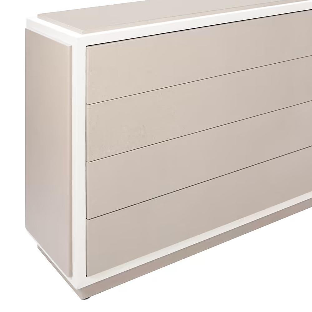 Chest of drawers Allia with all structure in wood. Chest covered 
with high quality beige grained calfskin leather CAT. A. and outlines
covered with high quality white grained calfskin leather CAT. A.
Drawers in wenge finish inside, drawers with