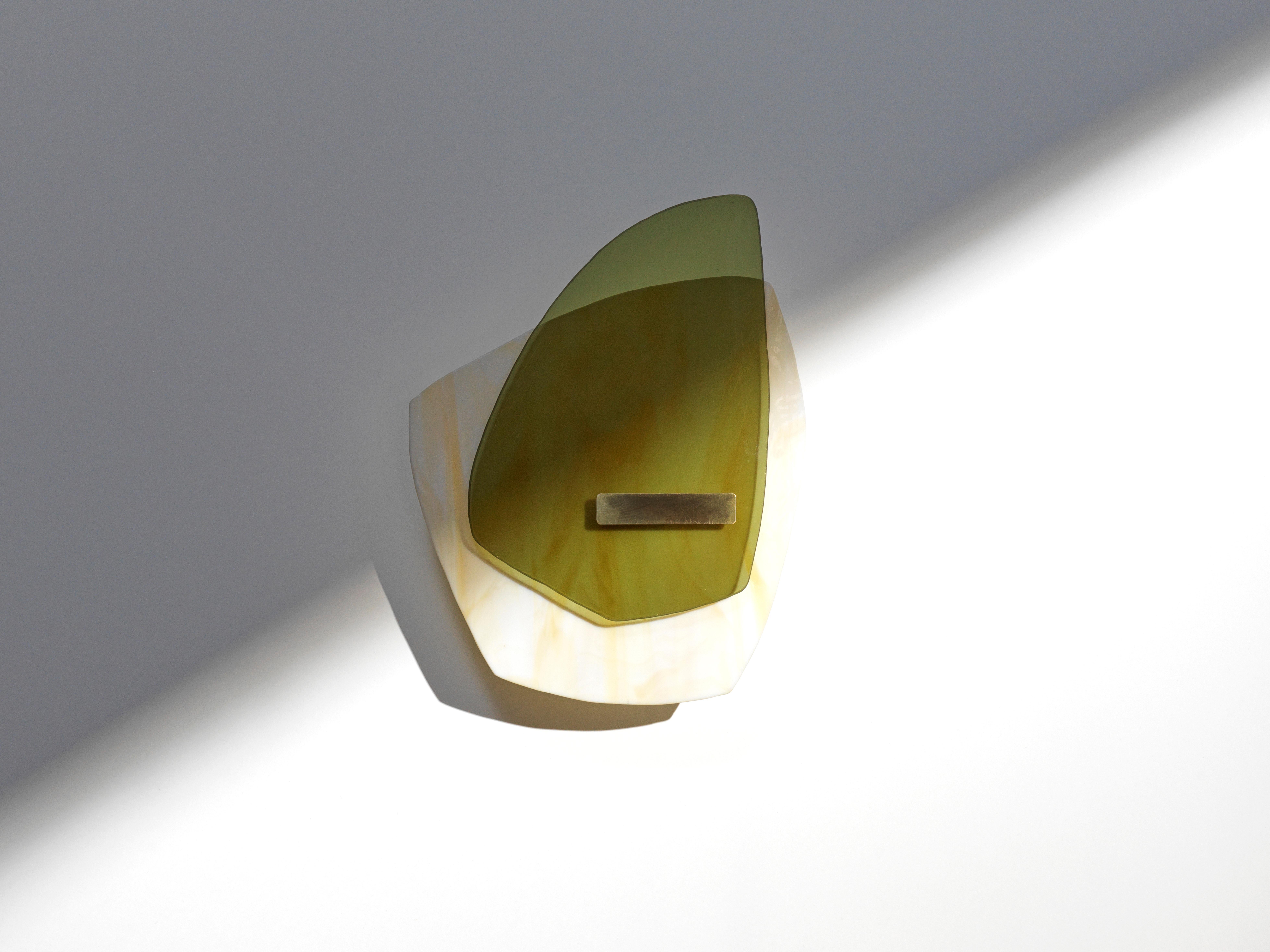 Alliance 03 light sculpture by Marie Jeunet.
Dimensions: H 35 x L 26 cm
Materials: Semi opaque ochre marbled glass, smooth olive green glass sheet, brushed brass structure and finish

Les Precieux 
These luminous sculptures evolve with the