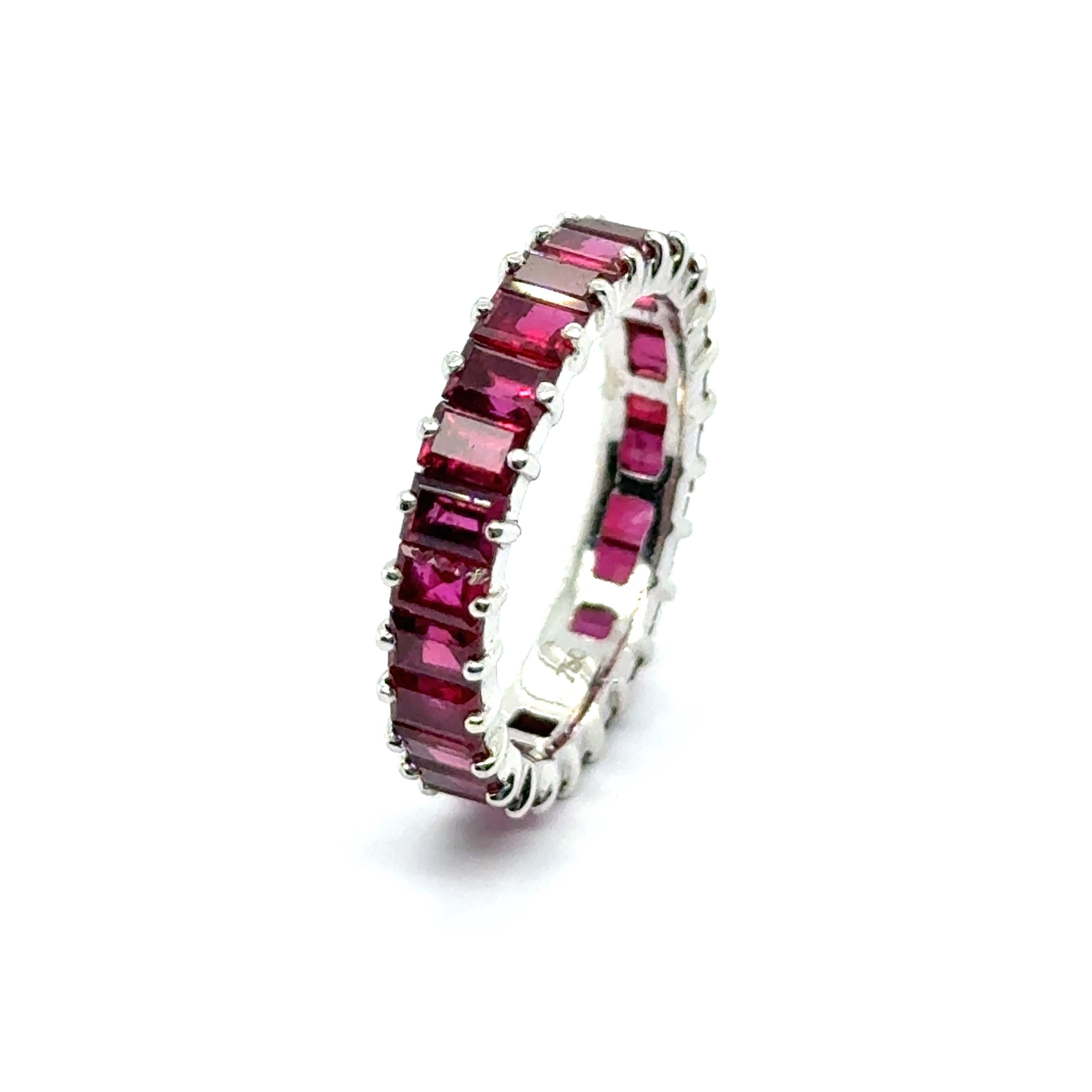 Introducing a captivating fiery alliance ring featuring 26 exquisite baguette-cut rubies, elegantly set in luxurious 18-karat white gold. With a total weight of 3.88 carats, each ruby is prized for its rich, vibrant hue and remarkable clarity,
