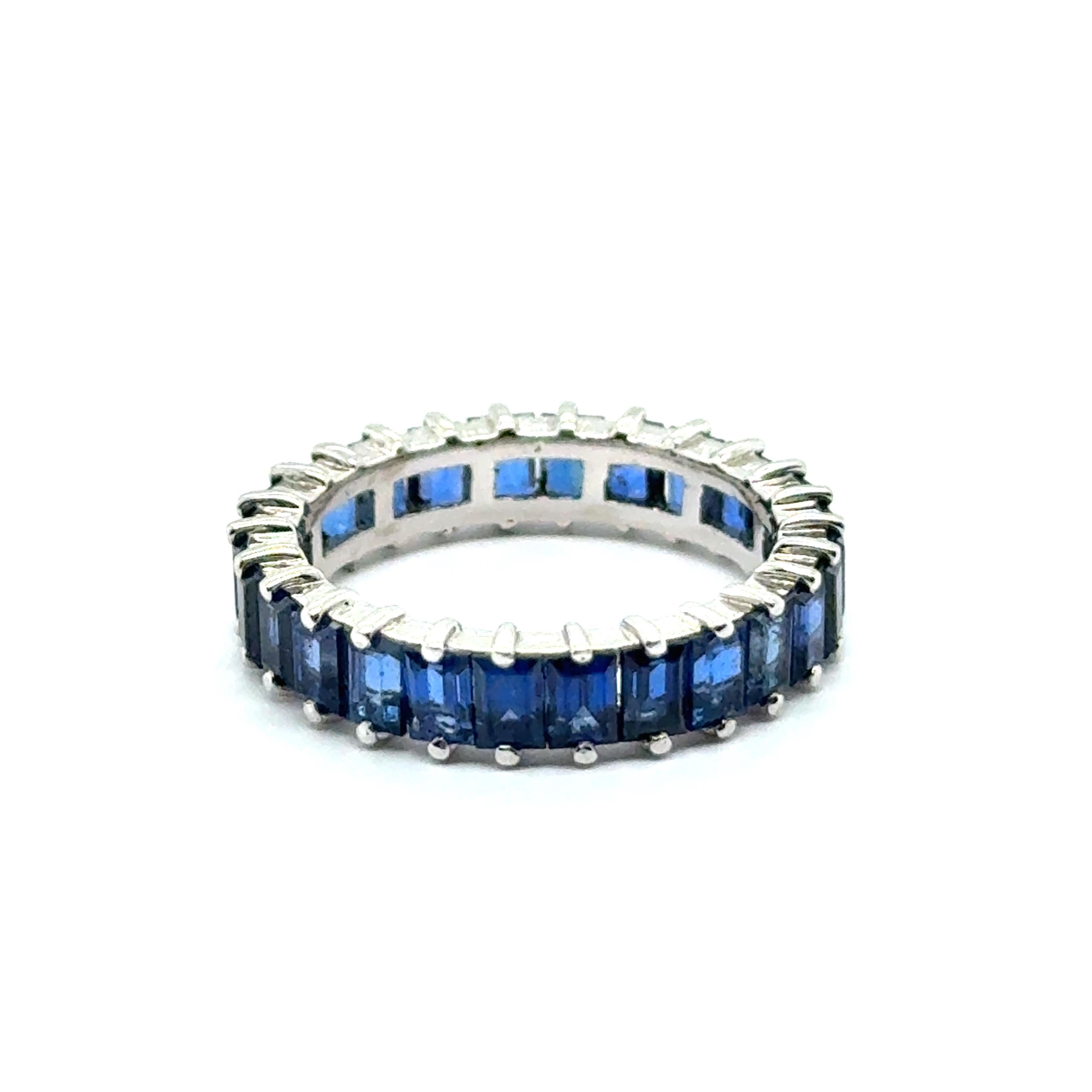 Crafted with elegance and sophistication, this alliance ring by Gübelin embodies timeless beauty. 

Set in 18-karat white gold, it features 26 baguette-cut blue sapphires totaling 4.00 carats, arranged in a seamless band that symbolizes unity and