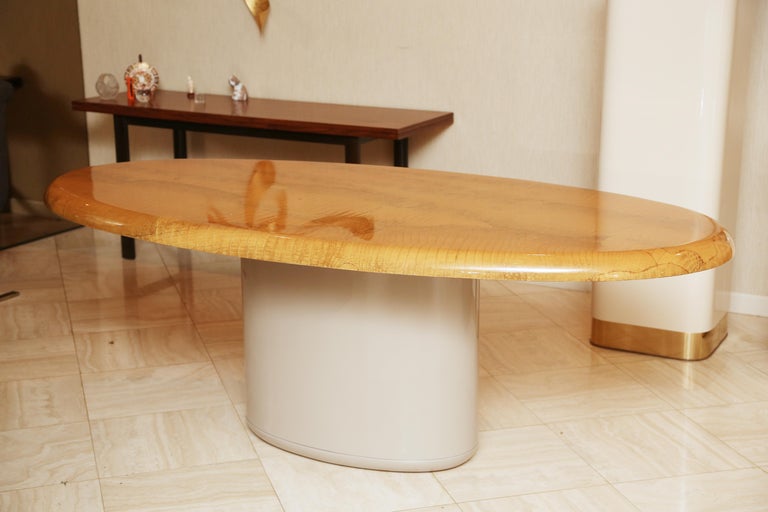 The oval top covered in lacquered and bleached alligator raised on a grey lacquered pedestal base.