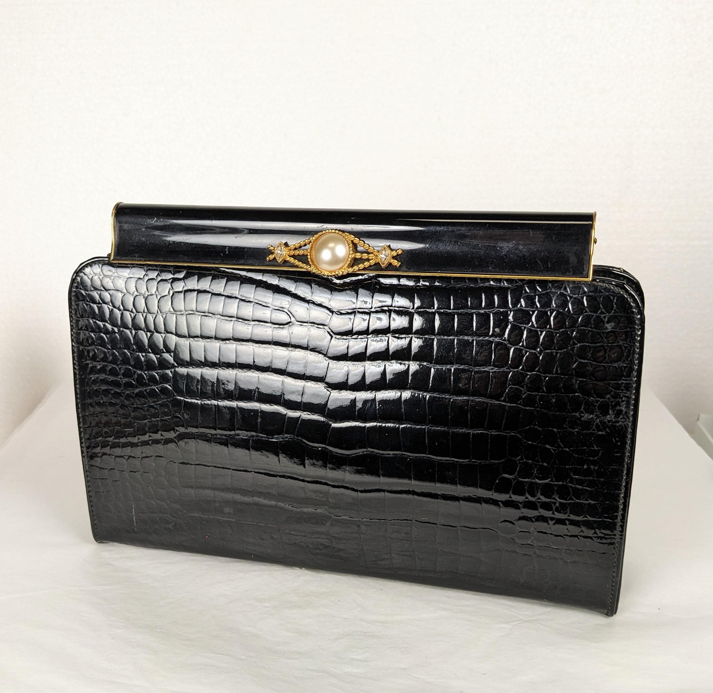 Alligator Grained Leather Clutch from the 1960's with gilt enamel clasp with crystal and faux pearl accents. Made by Lewis, NY. 
1960's USA. 8.5