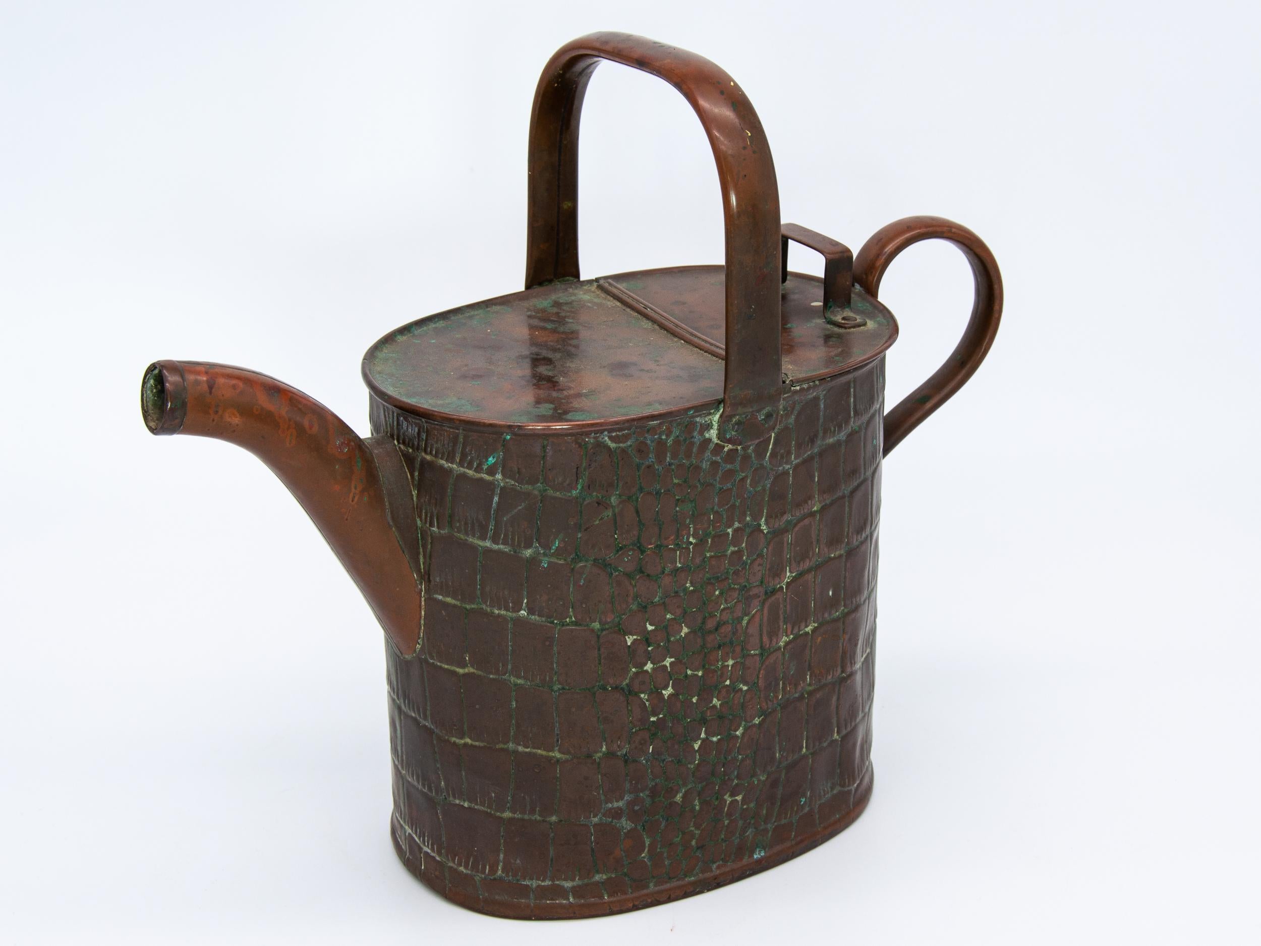 An antique copper watering can from the late 19th century. Desirable verdigris patination on the body.