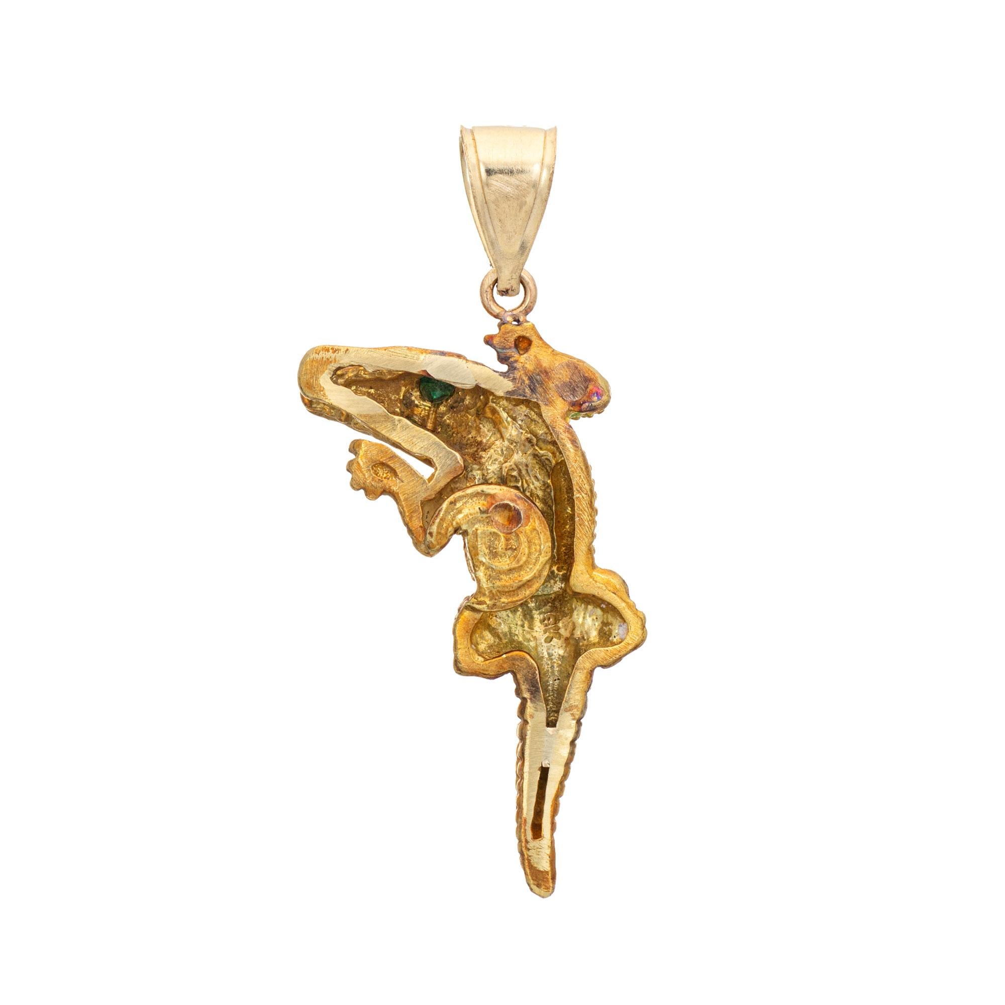 Finely detailed Alligator pendant crafted in 18 karat yellow gold. 

Two small estimated 0.01 carat emeralds are set into the eyes.

The beautifully detailed alligator features lifelike scale detailing, with mouth open and teeth visible. Measuring 1