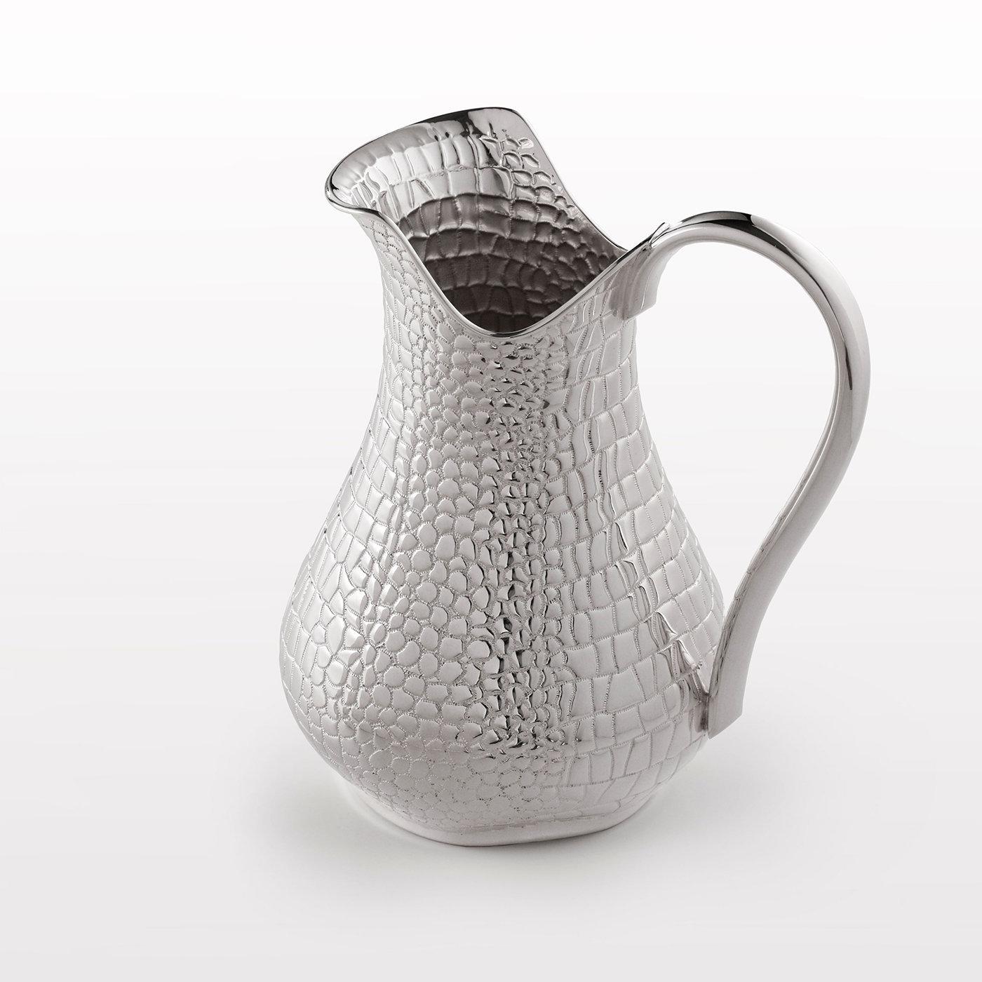 Handcrafted by internationally renowned master goldsmith Marco Fedi, this elegant pitcher in 999/°° silver will bring understated luxury to any table setting. Its crocodile skin-like texture is the result of a deft artisan process using spinning and