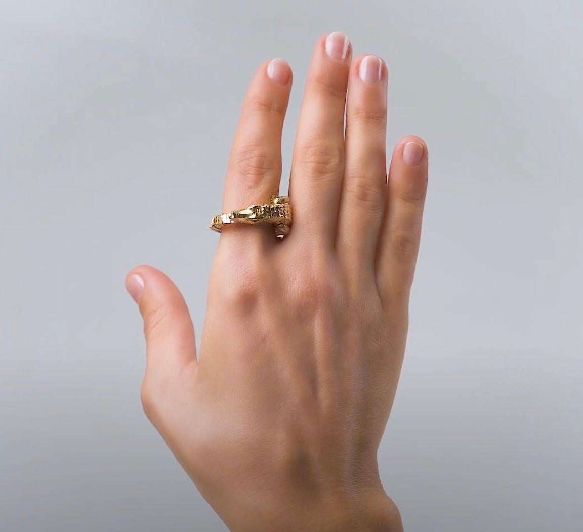 Playful yet with an opulent glamour, this piece is intriguing in its delicate mechanism. Designed as an intricately-crafted alligator in 18k yellow gold, the ring is entirely articulated, so that its body wraps around the finger. The alligator’s