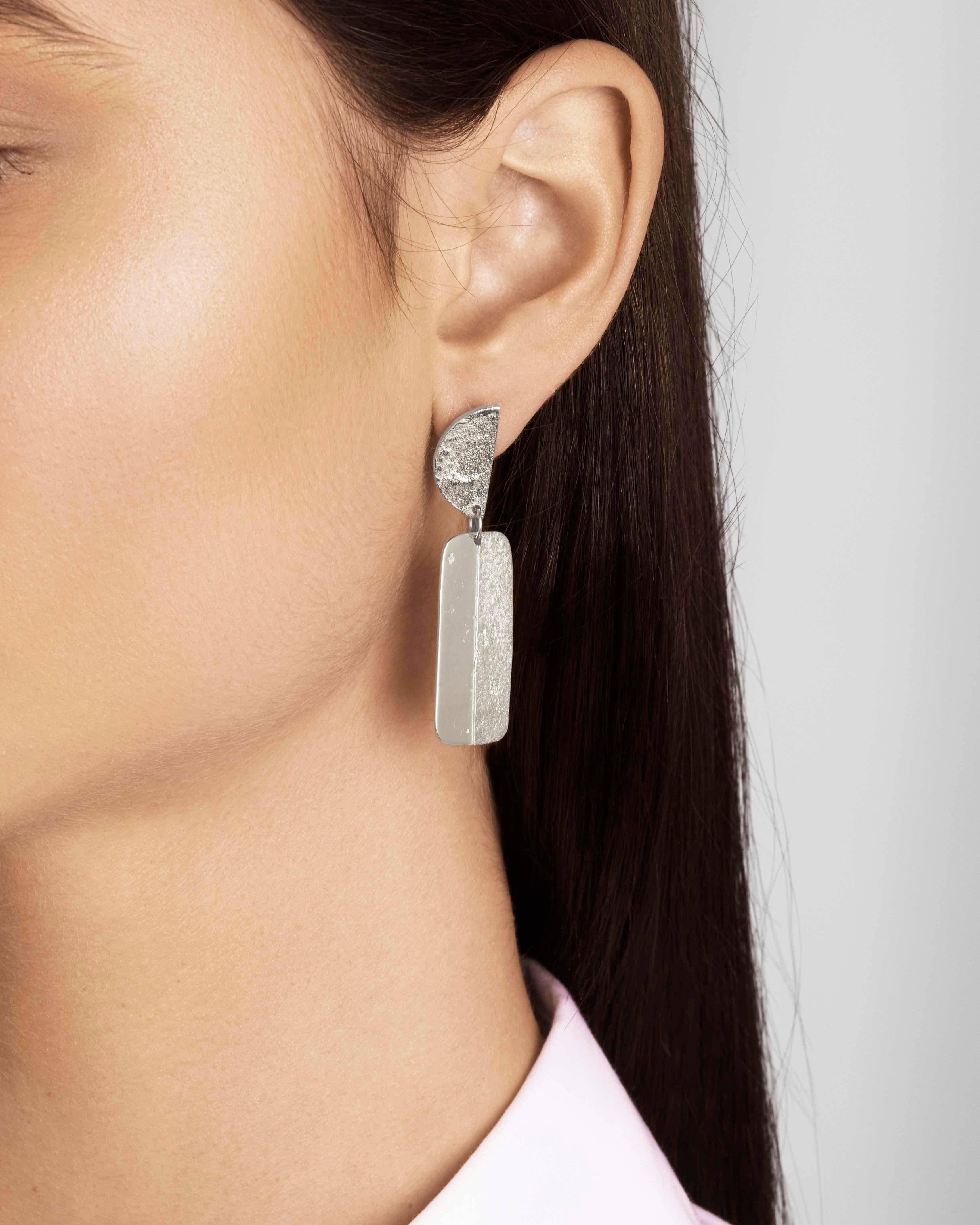 Articulated statement earrings with a combination of shimmering texture and a rustic high-polish finish. In sterling silver with a post and butterfly closure.  Earrings measure approximately 1.4 cm wide by 5 cm long. 

Handmade in London. 
