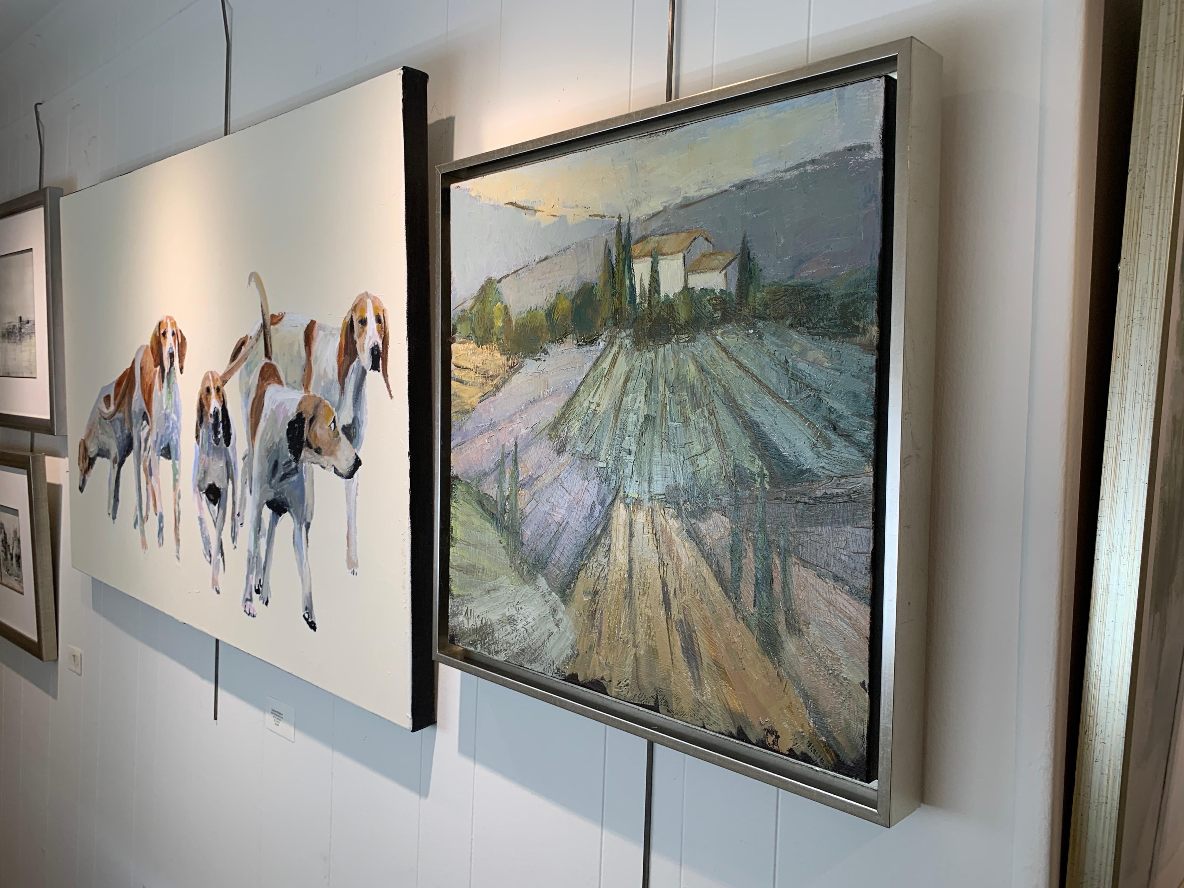 'See You Next Year I' is a framed Impressionist oil on canvas painting created by American artist Allison Chambers in 2020. Featuring a palette made of green, blue, neutral and purple tones, the painting depicts a vineyard leading our eye to the