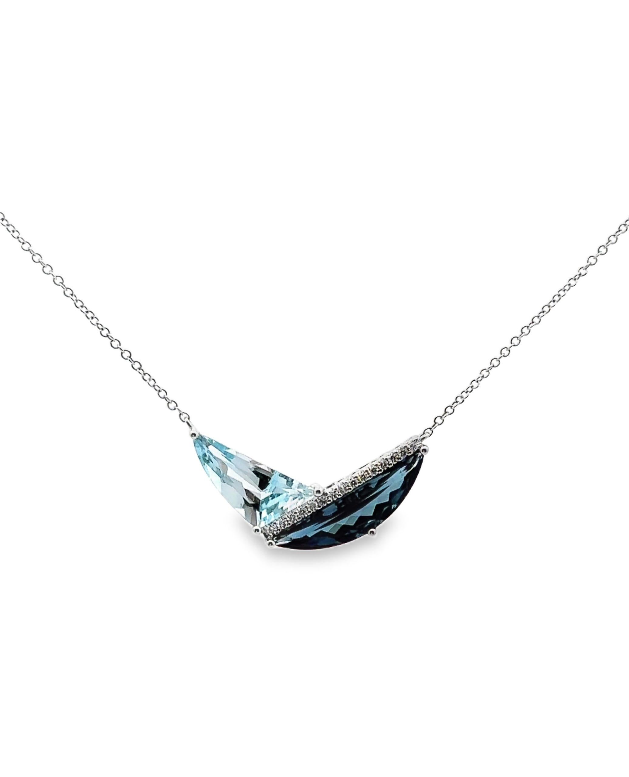 Allison Kaufmann 14K white gold necklace with one sky blue topaz weighing 2.16 carats and one London blue topaz weighing 2.50 carats. The piece is also furnished with 15 round brilliant-cut diamonds weighing 0.09 carats total.

- G color, SI1/2
