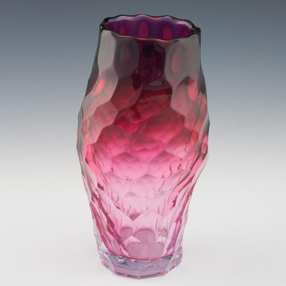 Heading : Allister Malcolm pink honeycomb vase
Date : 2023
Origin : Stourbridge, England
Bowl Features : Cranberry glass of asymmetrical form with honeycombe cuts. The colour graduates from the rim down
Marks : None
Type : Lead
Size : 25.1cm height,