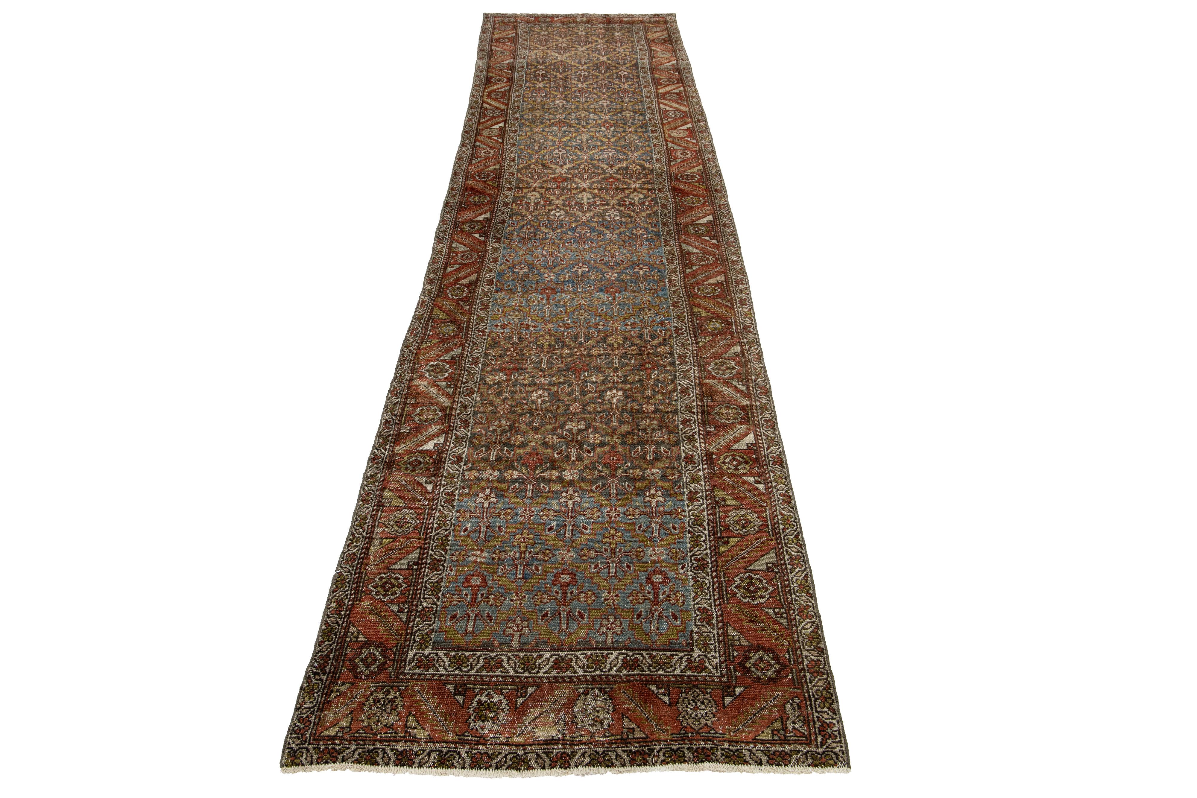This Persian Malayer wool rug has an antique charm. It features hand-knotted wool in a blue field, with a tribal pattern adorned with rust, gray, and yellow accents.

This rug measures 3'2