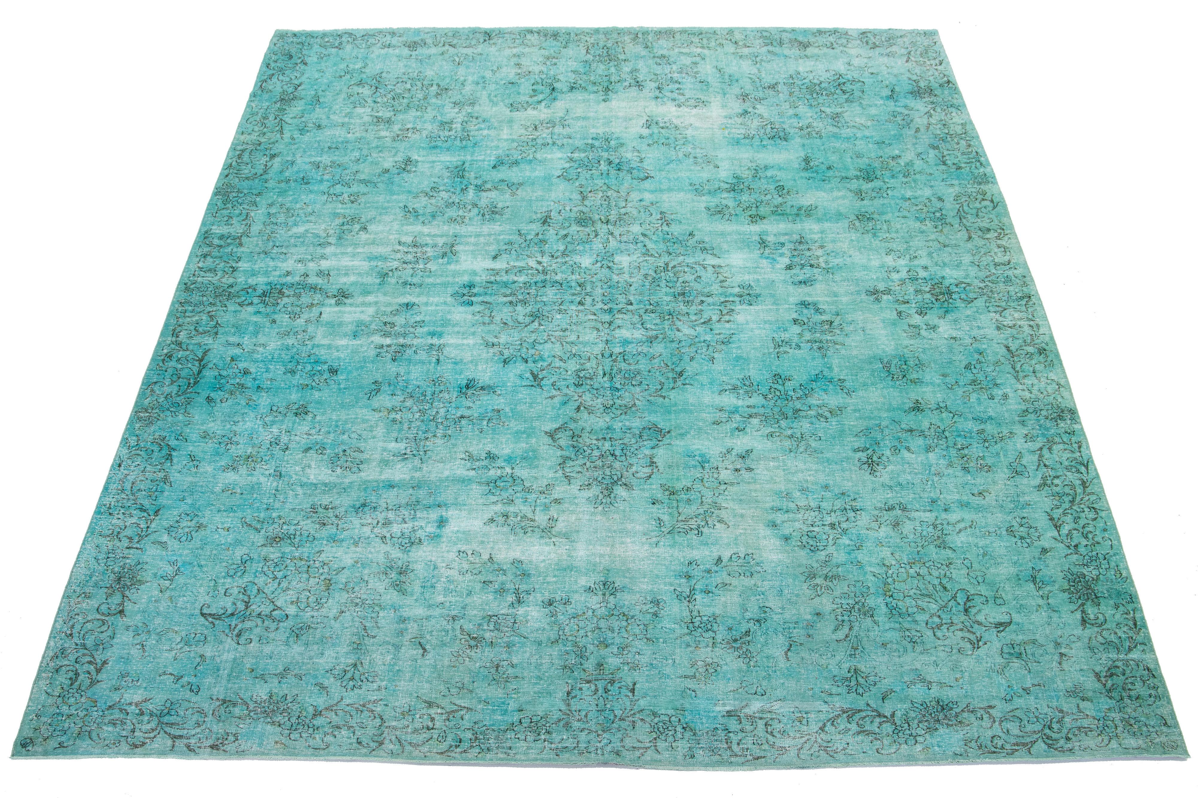 This is a Turquoise antique hand-knotted Persian wool rug with a medallion floral design and gray accents.

This rug measures 9'10'' x 13'7