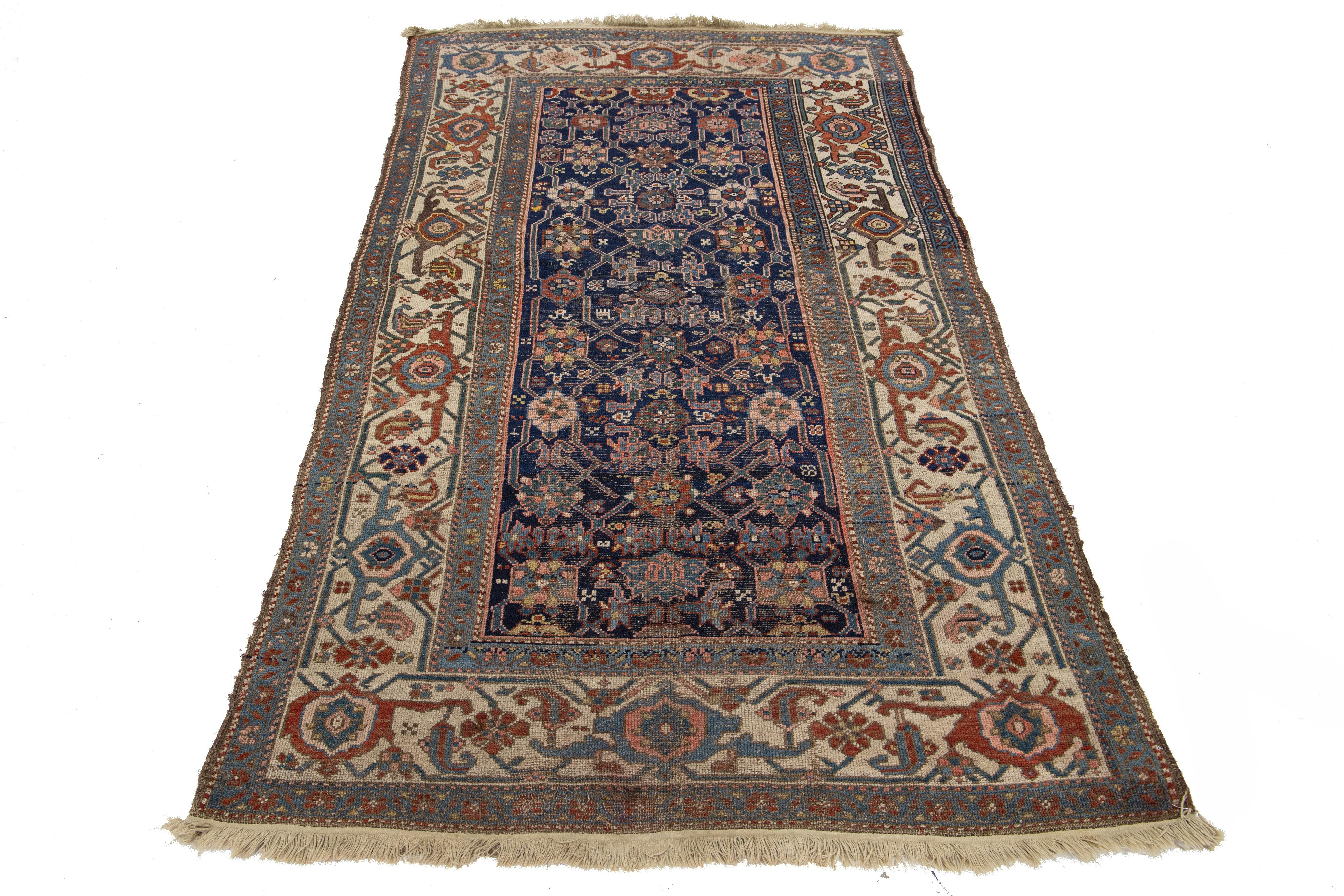 Dieser antike persische Bidjar-Wollteppich versprüht Charme. Es ist aus makelloser, handgeknüpfter Wolle in einem marineblauen Feld gefertigt, und das geometrische Blumenmuster ist mit mehrfarbigen Akzenten versehen. 

Dieser Teppich misst 4'2