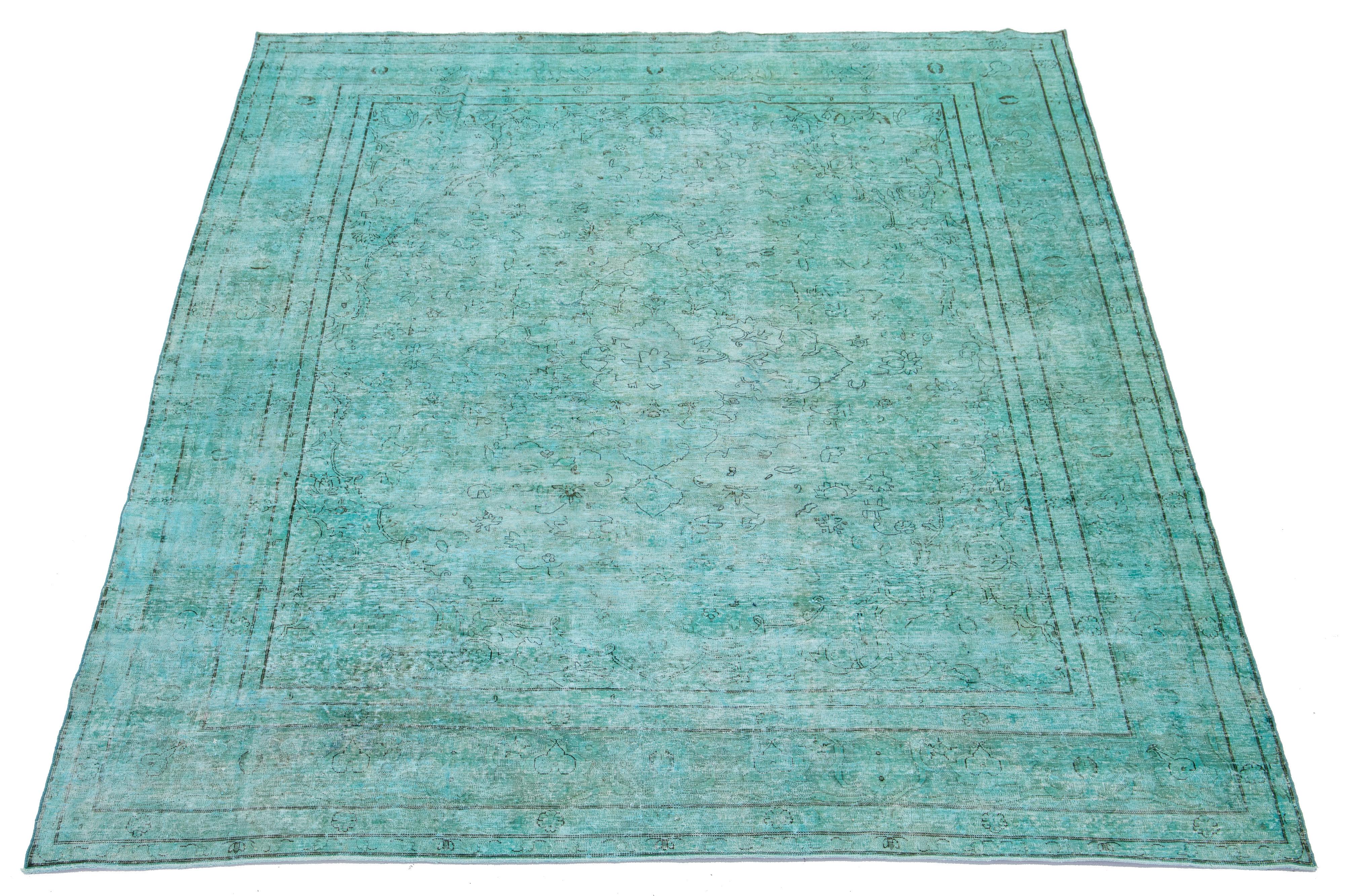 This is an antique hand-knotted wool Persian rug with a Turquoise field. It features an all-over floral design with gray accents.

This rug measures 8'5'' x 11'1